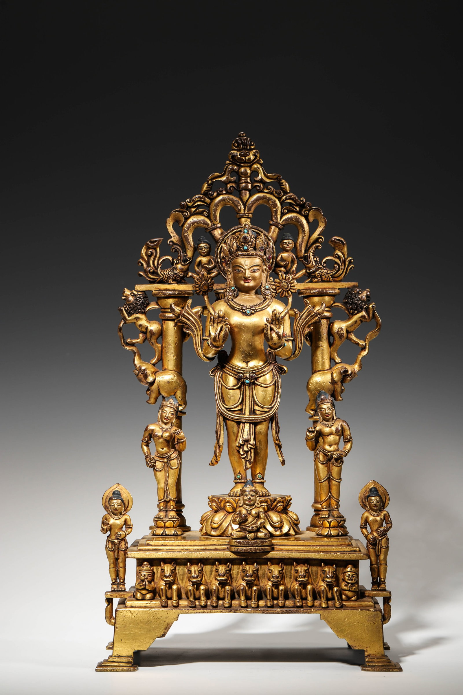 A GILT-BRONZE INLAID STONE PADMAPANI AVALOKITESHVARA STANDING STATUE PALA STYLE, MING DYNASTY: L: 22cm (8.66in) W: 14cm (5.51in) H: 40cm (15.75in) Weight: 5.2kg (11.46lb)A magnificent Ming Dynasty gilt-bronze Padmapani Avalokiteshvara in Pala style, finely cast with gem inlays, elaborate mandor