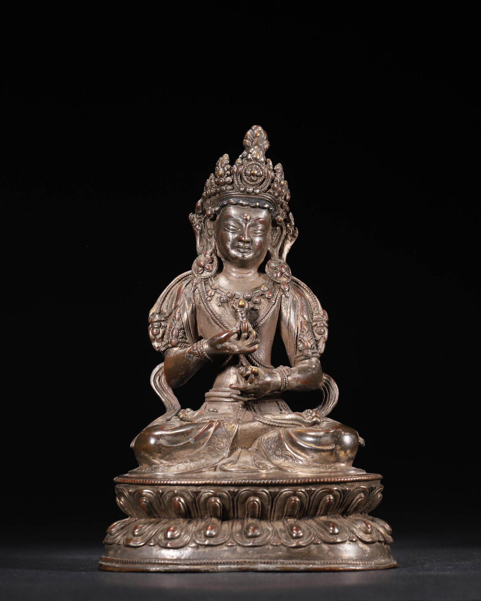 MING DYNASTY GILT-BRONZE SEATED BODHISATTVA HOLDING A VAJRA: 5.51 x 3.94 x 8.27 in (14 x 10 x 21 cm), 3.65 lbs (1654 g)A fine Ming Dynasty gilt-bronze seated Bodhisattva, holding a symbolic vajra. With a serene expression and ornate jewelry, it rests on a plump
