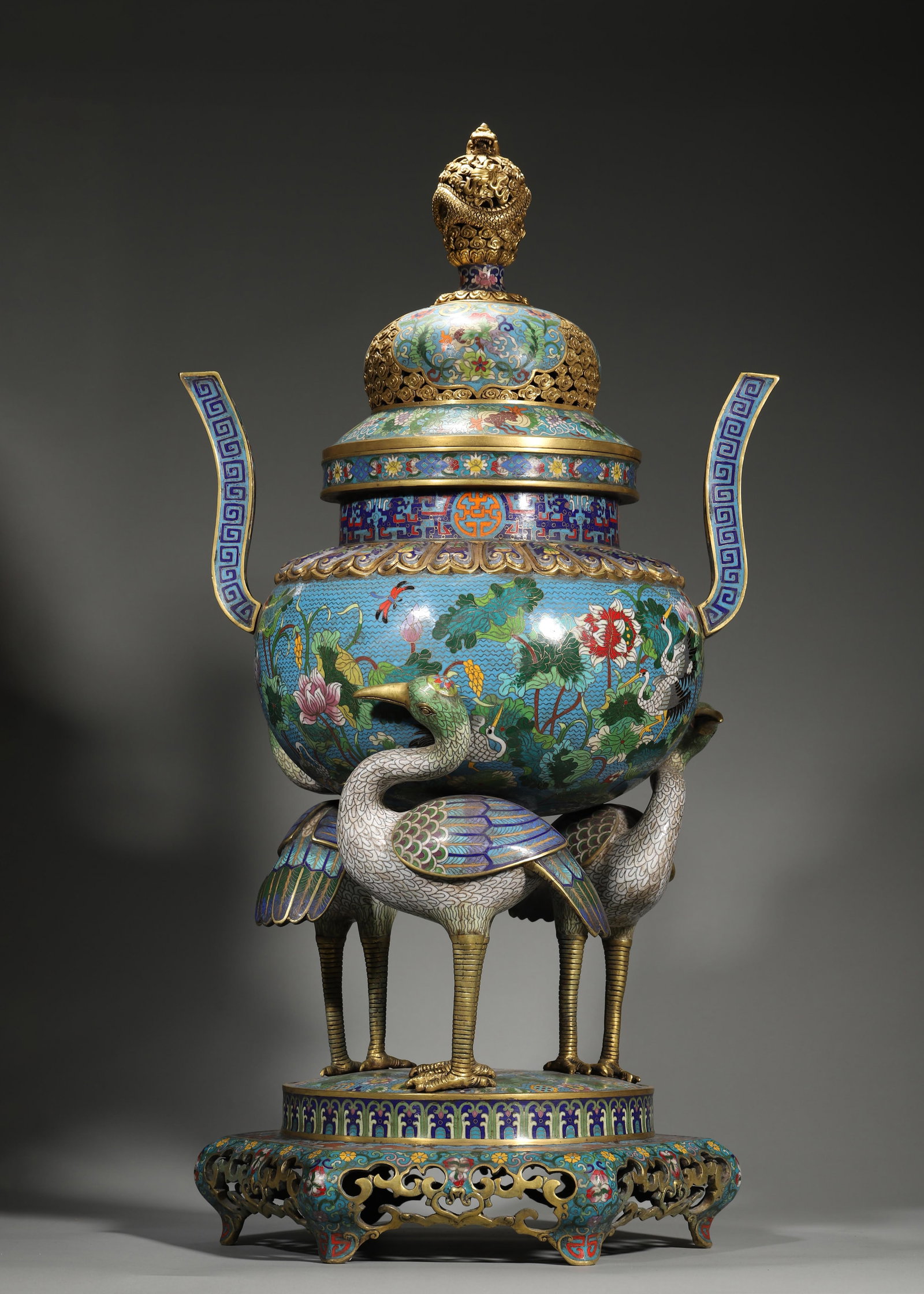 A MAGNIFICENT GILT-BRONZE AND CLOISONNÉ ENAMEL 'LOTUS AND CRANE' INCENSE BURNER AND STAND, QIANLONG: 16.14in x 12.99in x 29.53in (41.0cm x 33.0cm x 75.0cm), 55.777lb (25300.0g)This imperial Qianlong cloisonné censer features gilt-bronze dragon finial, crane-form legs, and lotus pond patterns. A mast