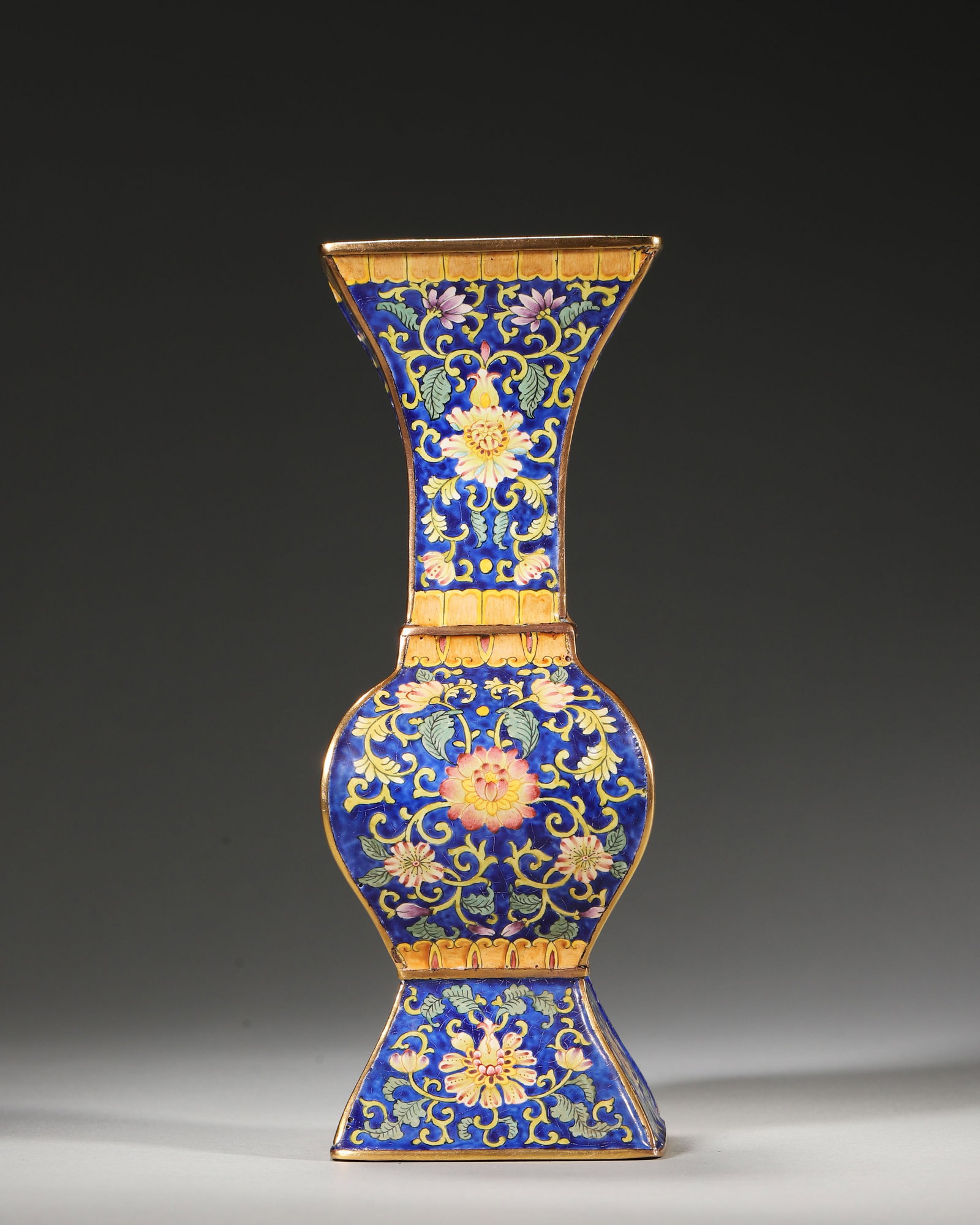 QIANLONG PERIOD, QING DYNASTY COPPER-BODIED ENAMEL GU VASE WITH THREE ABUNDANCES AND FLORAL MOTIFS (1 of 7)