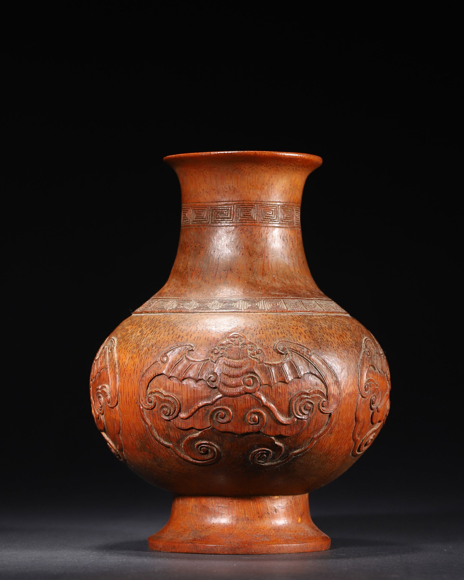 MID-QING DYNASTY, A BAMBOO CARVED VASE WITH BAT AND CLOUD PATTERN: 5.51in x 7.48in (14.0cm x 19.0cm), 0.93lb (422.0g)This Mid-Qing bamboo vase, modeled after a Yuhuchunping, is carved with bats and clouds, symbolizing good fortune. It features an elegant shape, delic