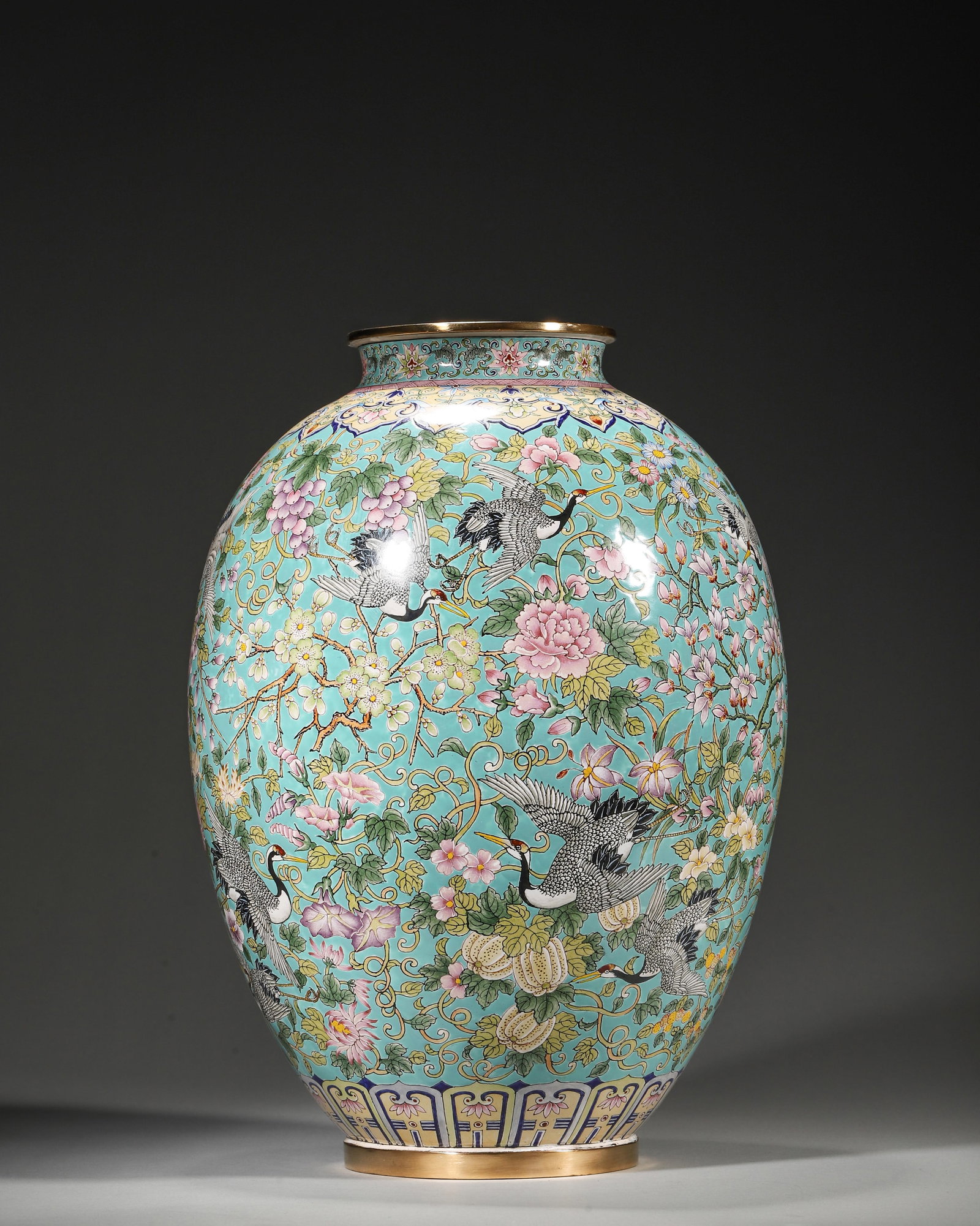 QIANLONG PERIOD, QING DYNASTY COPPER-BODIED ENAMEL OLIVE VASE WITH CRANE AND THREE ABUNDANCES MOTIFS: 8.66in (22.0cm), 4.447lb (2017.0g)A fine Qianlong period copper enamel olive vase with turquoise ground, cranes, floral scrolls, and three abundances motifs. Marked "Da Qing Qianlong Nian Zhi", exempl