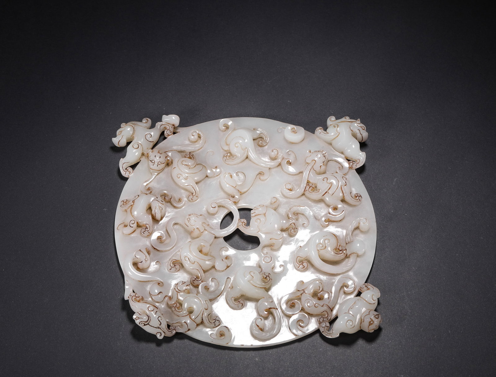 White Hetian Jade Disk Pendant with Chilong Patterns, Han Dynasty: H:21.4cm (8.43in) W:20.5cm (8.07in) Weight:461g (1.02lb)This jade bi disc is a masterpiece of ancient jade craftsmanship in the Han Dynasty. Carved from top-quality Hetian white jade, it features high