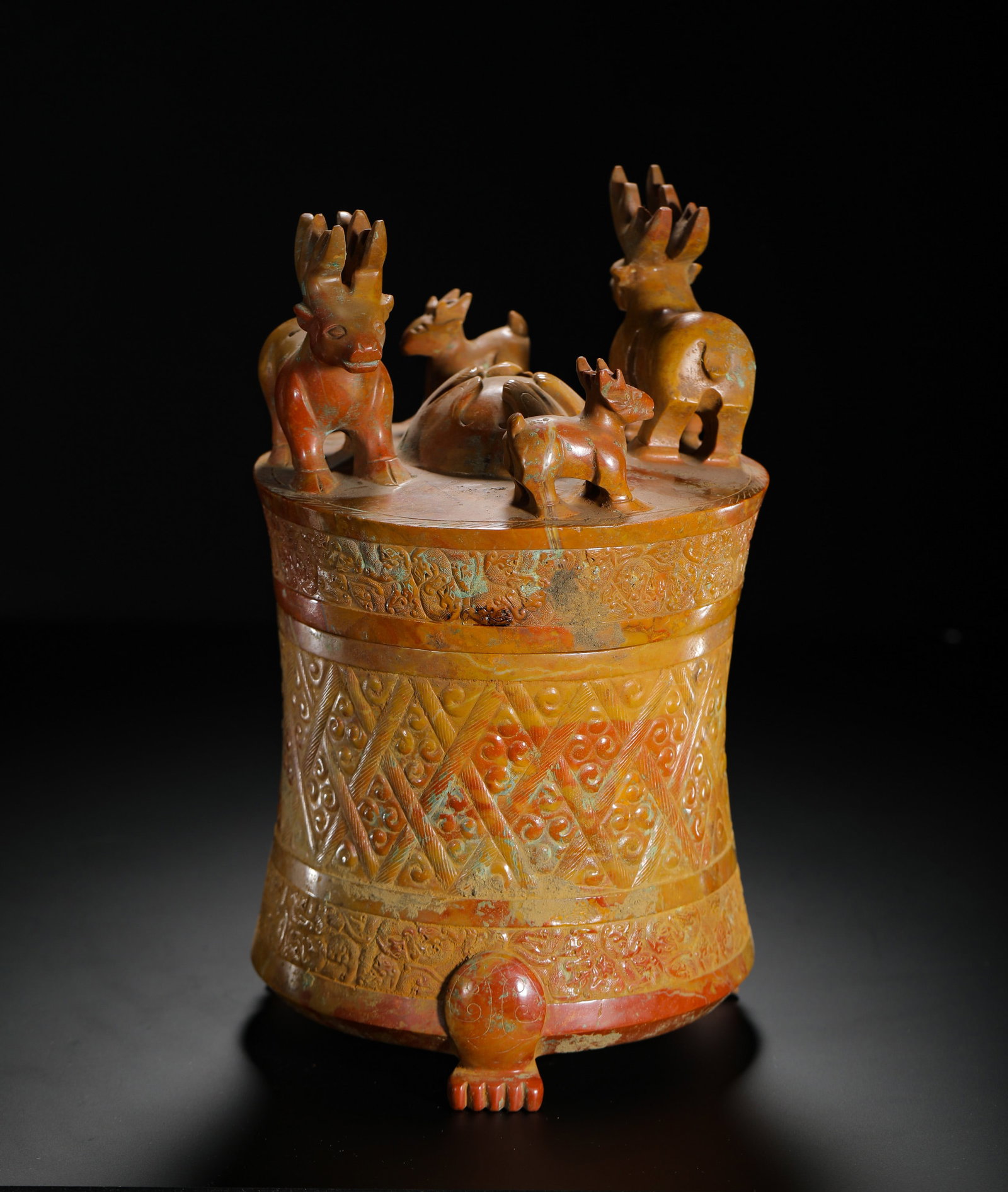 Jade Cylindrical Tripod Vessel with Deer Pattern, Han Dynasty: H:28cm (11.02in) W:14.5cm (5.71in) Weight:2870g (6.33lb)This is a Han Dynasty red-patinated jade cylindrical vessel, carved with a group of deer on the lid, cloud and beast patterns on the body, and s