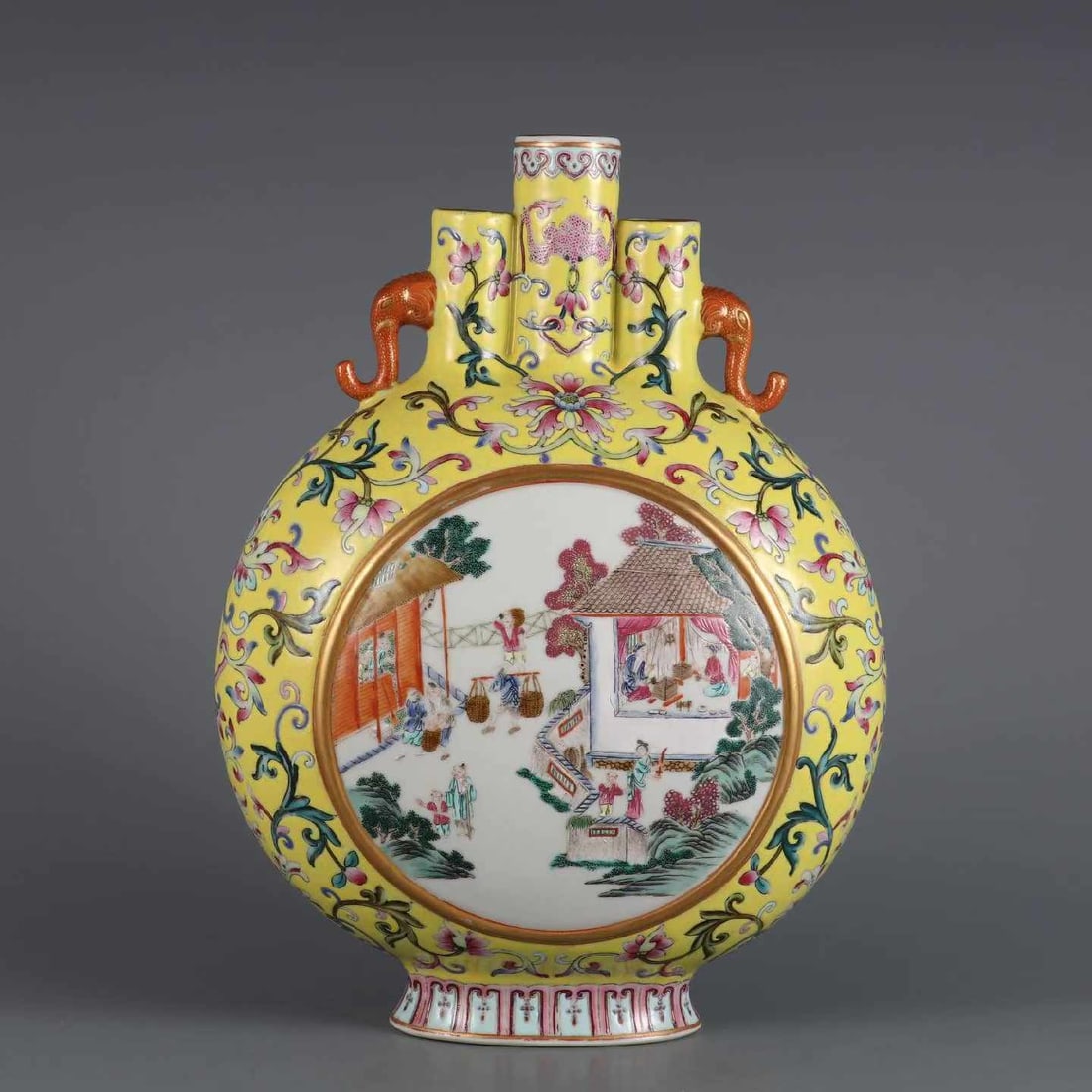 Yellow-Ground Famille Rose Triple-Tube Moon Flask with Elephant Handles, Qing Dynasty: A yellow-ground famille rose triple-tube moon flask, Qianlong period, Qing dynasty, of imperial quality. The vessel is fully decorated with scrolling lotus flowers on a rich yellow ground, flanked by 