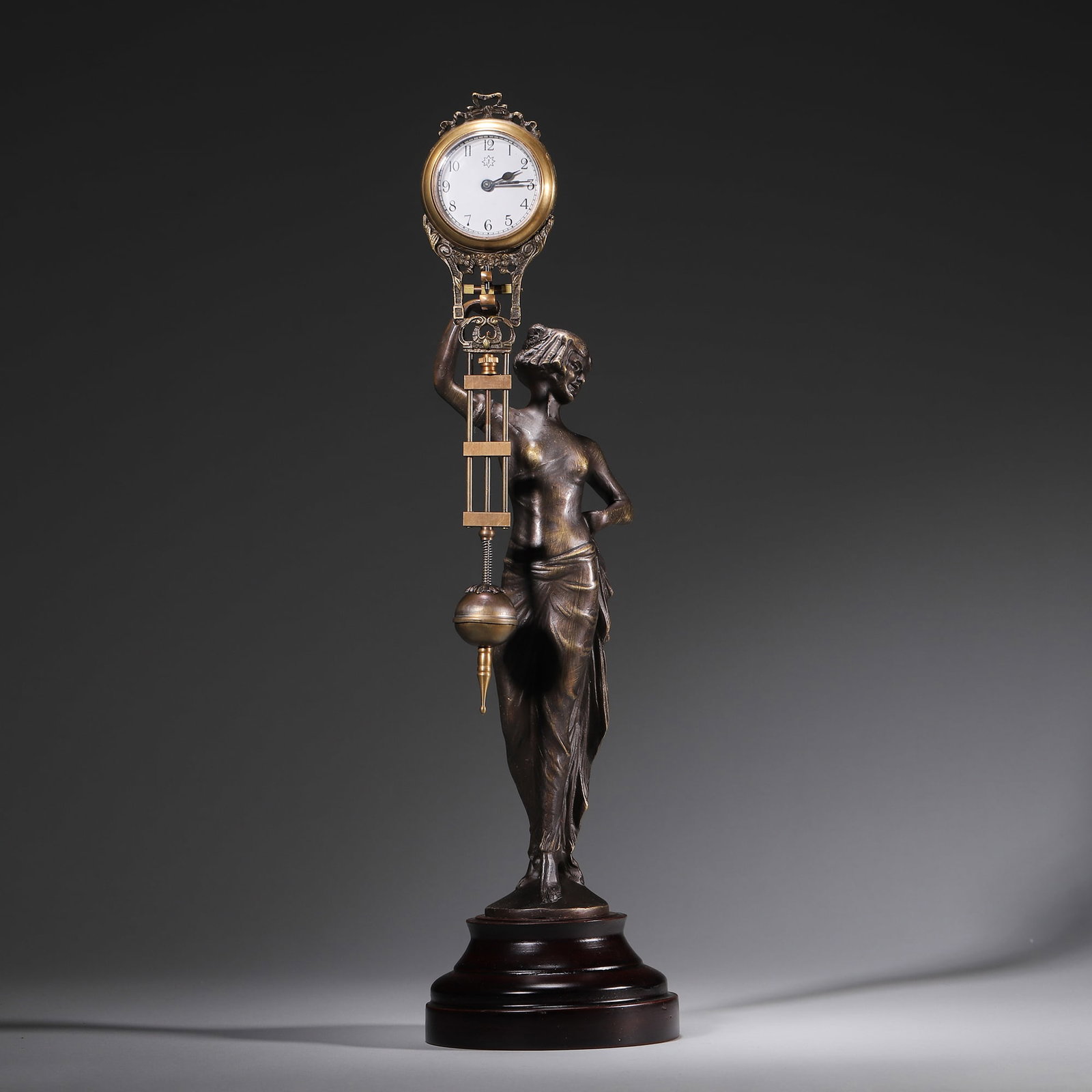 19th Century European Bronze Goddess Statue Swing Pendulum Clock: An Art Nouveau European bronze swing pendulum clock dating to the 19th century. The clock is centered on a cast bronze figure of a goddess with finely rendered drapery and a natural aged bronze patina