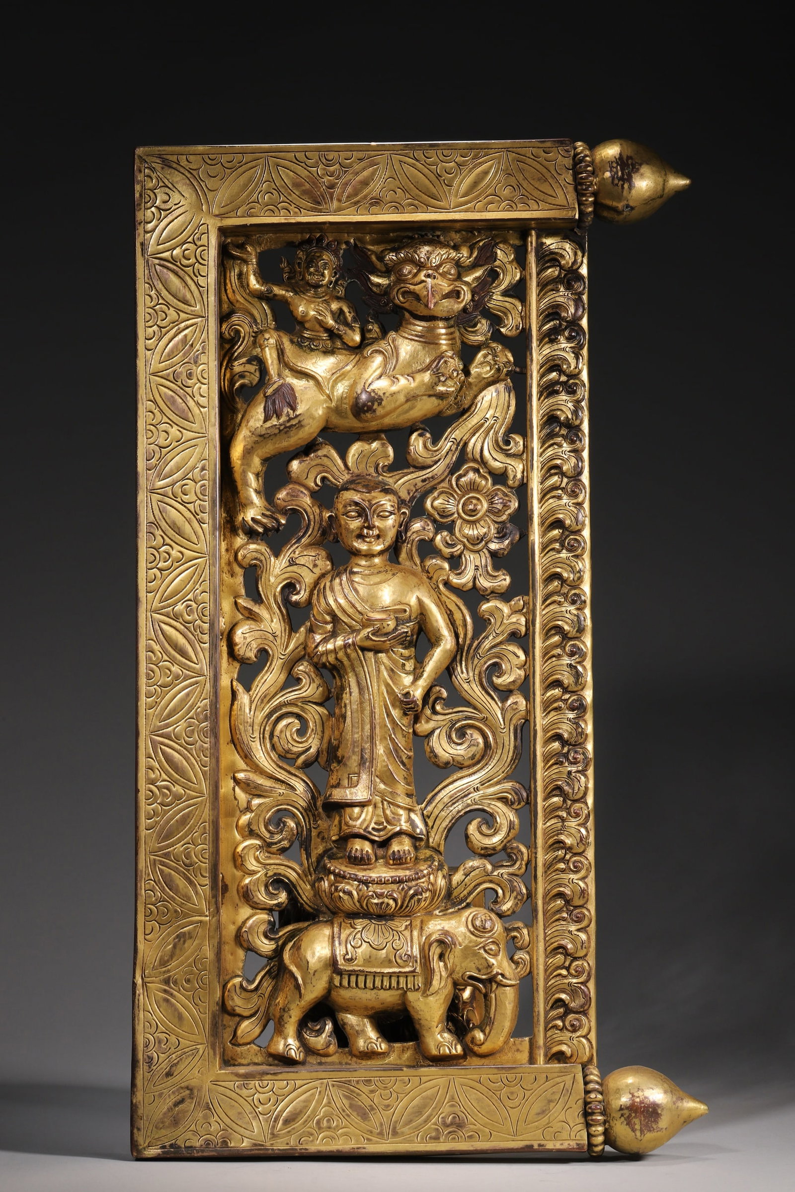 A Gilt Bronze Openwork Panel With Sakyamuni And Mythical Beasts - Qing Dynasty: Length 29.0cm (11.42 in); Height 50.0cm (19.69 in); Weight 1780.0g (3.92 lb)A gilt bronze openwork panel of the Qing Dynasty, likely a Buddhist shrine fitting. Features a standing Sakyamuni with an al