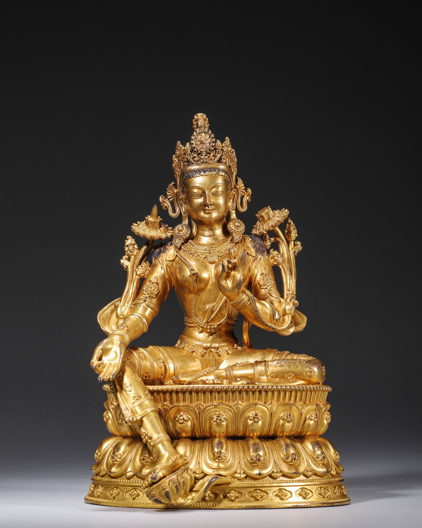 Qing Dynasty, Gilt Bronze Seated Statue of White Tara: A fine gilt bronze White Tara statue of Qing Dynasty for Tibetan worship. Fully covered with thick intact gilding. The serene deity wears ornate jewelry, holds lotus blossoms, and sits in relaxed pose