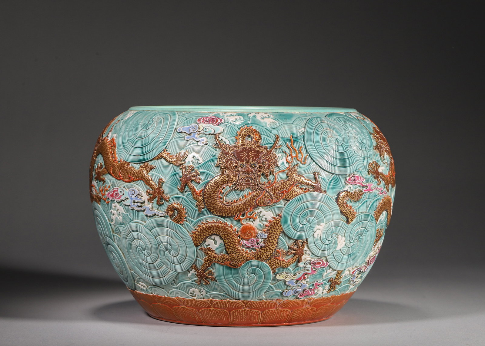 Qing Dynasty, Qianlong Period, Turquoise-Ground Fish Jar with Iron-Red Five Dragons: Qianlong marked large porcelain jar with turquoise glaze. Deeply carved sea waves with five gilt iron-red dragons amid colorful clouds. Lotus band at base, turquoise interior, gilt six-character Qianl