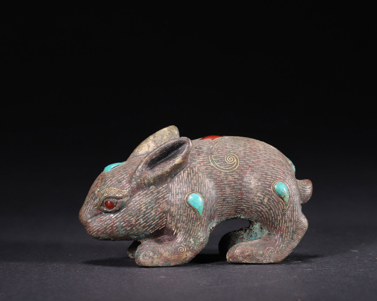Han Dynasty, Gold and Silver Inlaid Bronze Rabbit Paperweight with Inlaid Gems: A Han Dynasty bronze rabbit-shaped paperweight inlaid with gold, silver, turquoise and agate. Features fine silver-lined fur texture, vivid gem-set eyes, and natural patina. A rare example of imperial