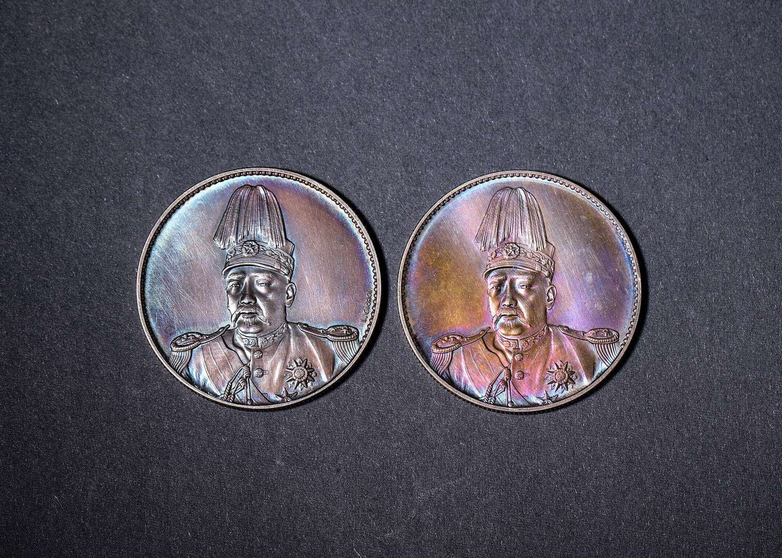 Two Yuan Shikai Republic Commemorative One-Dollar Silver Coins, Republic of China (1912-1949): Two ROC commemorative silver coins with Yuan Shikai military bust on obverse. Reverse bears inscriptions, wreath and denomination. Gorgeous colorful toning, intact relief and regular rims.