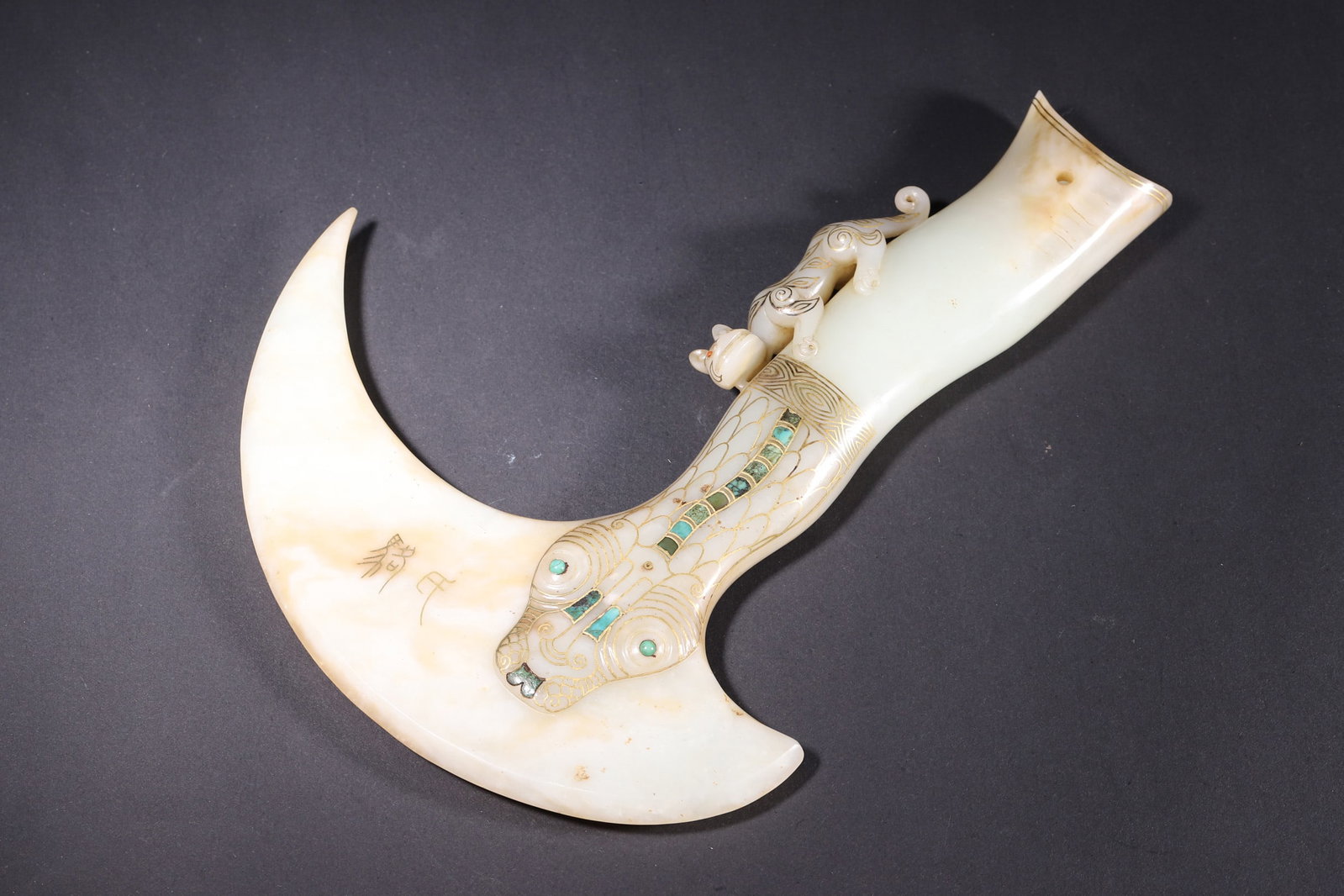 A Gold-Inlaid Turquoise-Embedded Jade Axe with Chilong Pattern-Warring States Period: Crafted from fine Hetian white jade with subtle russet patina, this axe features exquisite Warring States Period gold-inlaid and turquoise-embedded craftsmanship. The beast-face and scale patterns are