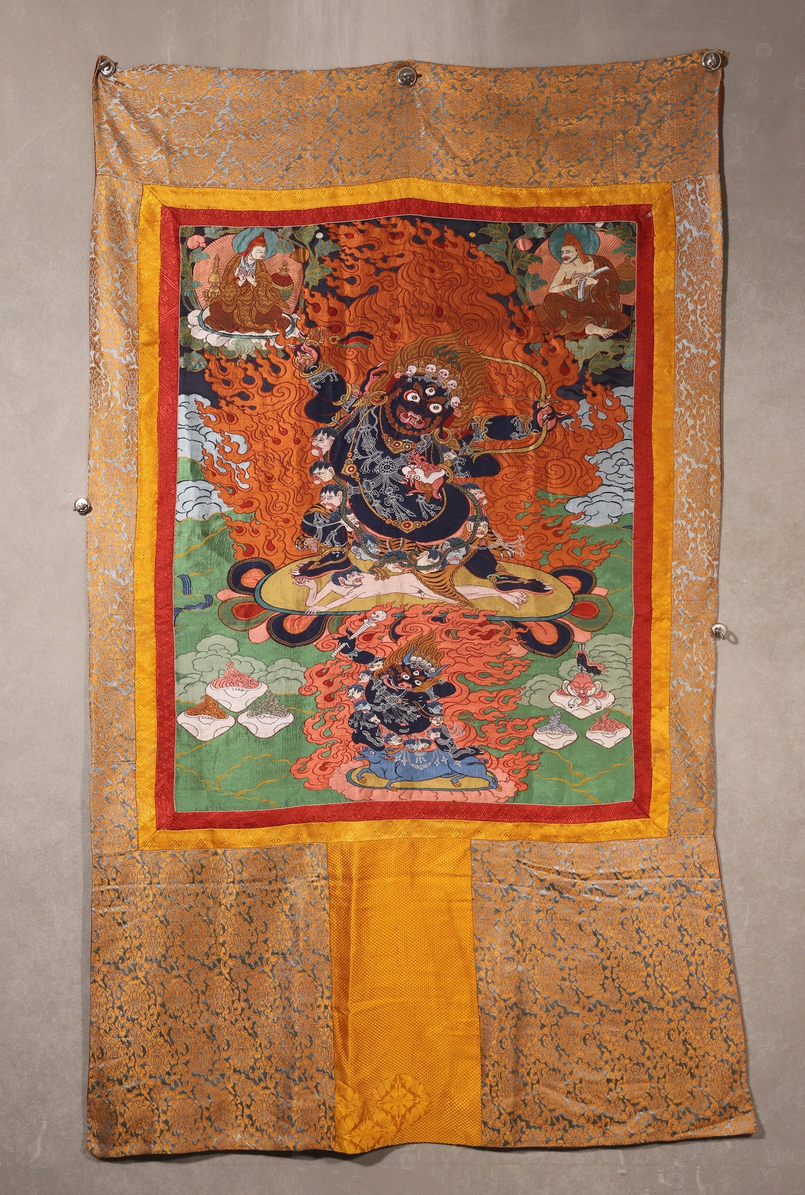 Qing Dynasty, Embroidered Thangka of Mahakala: A Qing Dynasty embroidered thangka of Mahakala, the fierce protector deity. Exquisitely crafted with fine embroidery, featuring the wrathful black-skinned deity holding a bow, surrounded by flames, wi