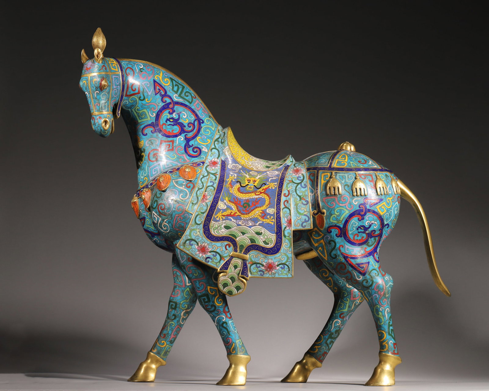 Qing Dynasty, Gilt Bronze Cloisonné Horse Ornament: This horse ornament is made of gilt bronze with fine cloisonné enamel. The horse stands with its head raised, decorated with dragon and wave patterns on the saddle, and features vivid enamel colors a
