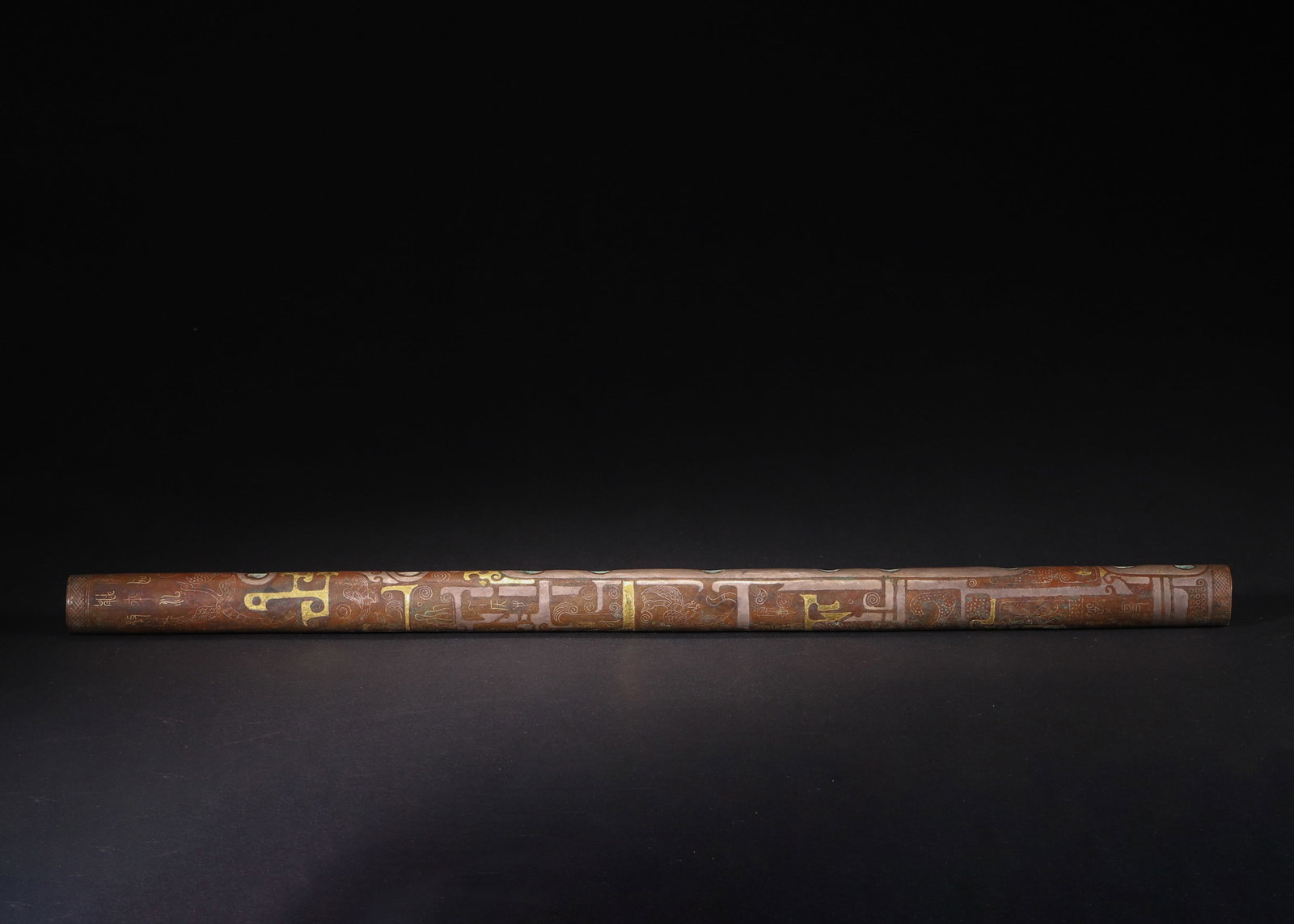 Warring States to Han Dynasty, Gold and Silver Inlaid Bronze Flute with Phoenix: A Warring States to Han Dynasty bronze flute, finely decorated with gold and silver inlaid phoenix, geometric, and calligraphic motifs. Features well-defined tone holes, superb craftsmanship, and anci