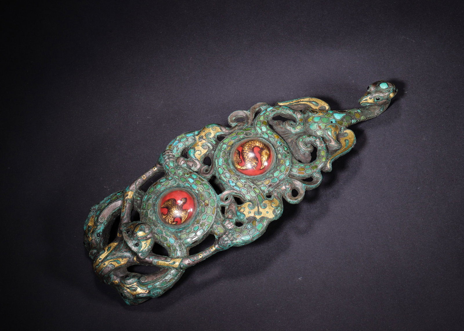 Warring States Period, Gold, Silver, Turquoise, and Glass Inlaid Openwork Belt Hook: Elite Warring States bronze ritual waist fitting with phoenix-shaped hook head set with turquoise on forehead and black stone eyes, feather details outlined by gold and silver wire. Double-layer openw