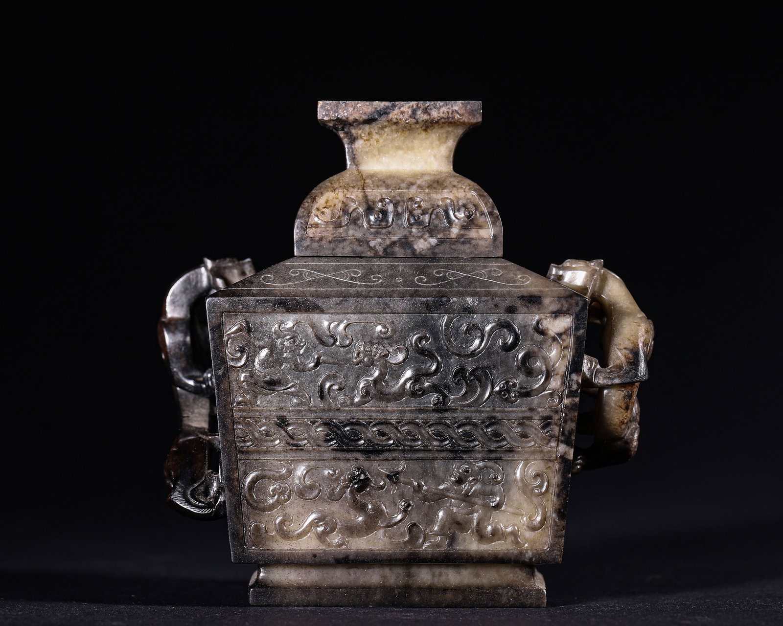 Han Dynasty, Hetian Jade Square Covered Vase with Chilong Handles: Hetian jade square vessel with fitted cover. Heavily black infiltrated patina with yellow white jade matrix. High relief chilong form side handles. Body carved with chilong, beasts and figures, accent