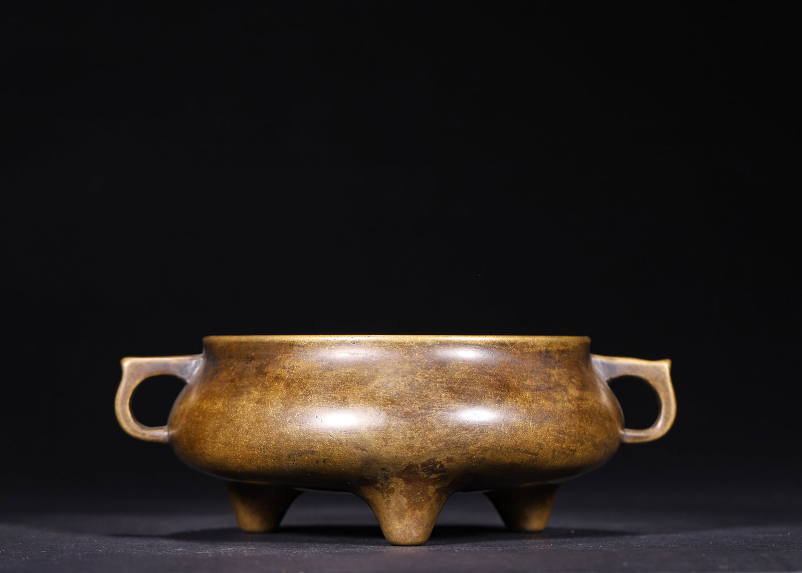 Ming Dynasty, Xuande Period, Bronze Tripod Censer with Flat Loop Handles: A bronze tripod censer from Xuande reign of Ming Dynasty, crafted from fine copper with flat loop handles, rounded belly and three solid feet. It bears the six-character mark "Da Ming Xuan De Nian Zhi