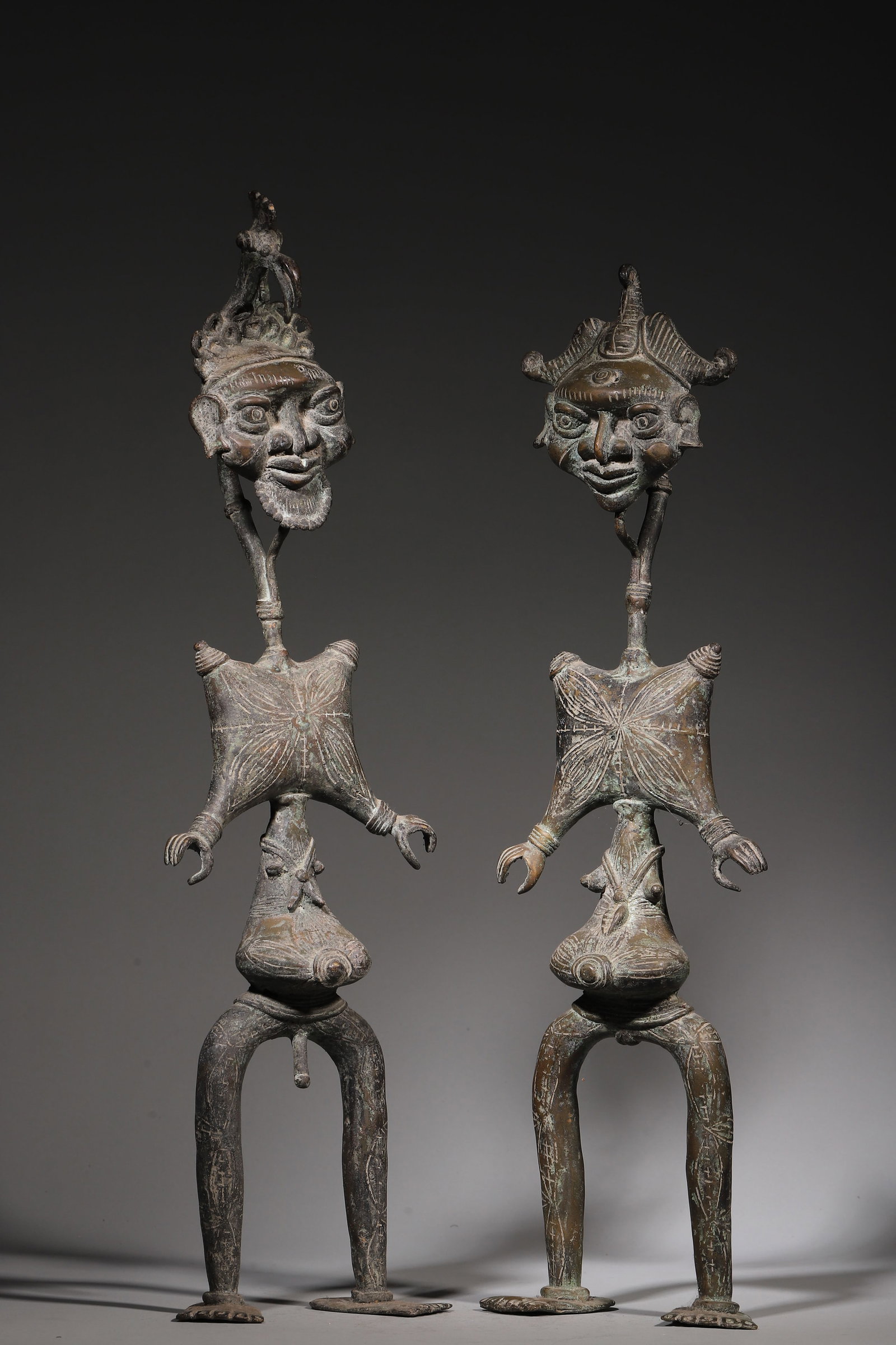 Bamileke Bronze Figure (Pair) 19th Century: Lost-wax-cast bronze paired-male-female figures of the Bamileke-Bamun peoples of Cameroon date to the 19th century, installed on clan ancestral altars for spousal-ancestor commemoration. Male-female