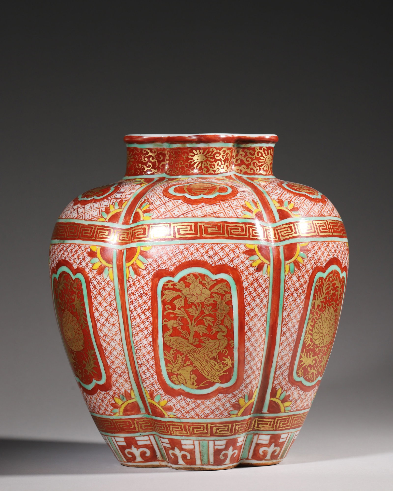 Ming Dynasty, Jiajing Period, Wucai Gold-Decorated Quinquefoil Jar with Wanshou Motifs: A Ming Jiajing official kiln quinquefoil jar with blue reign mark, red ground painted with gold peacocks, lotus and longevity characters, decorated with green and yellow borders, rich gilding, classic