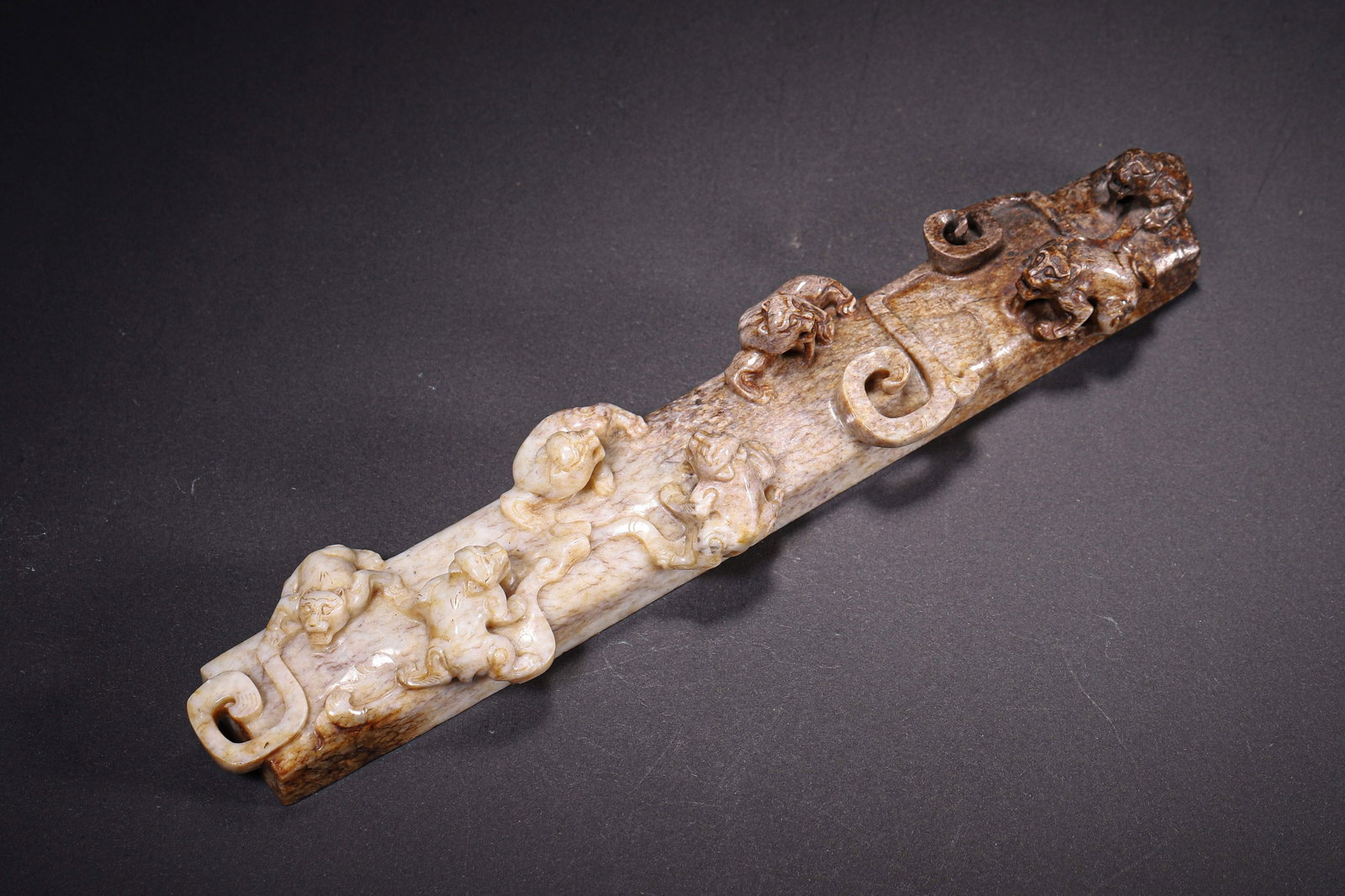 Han Dynasty, Hetian Jade Paperweight with High-Relief Multiple Chilong: Hetian jade with varied brown patina and partial calcification. Rectangular paperweight form. Surface decorated with multiple dynamically posed high relief chilong dragons and scroll cloud elements. R