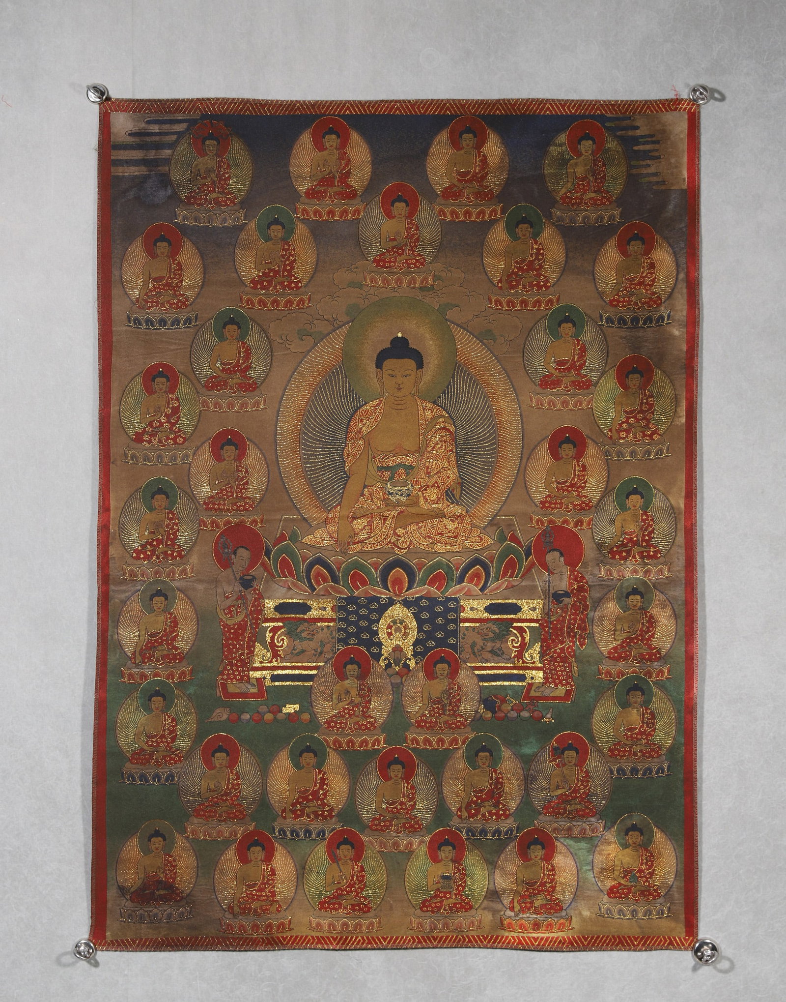 Qing Dynasty, Embroidered Thangka of Thirty-Five Buddhas: A Qing Dynasty embroidered thangka depicting Thirty-Five Buddhas, with Sakyamuni Buddha seated at the center, surrounded by thirty-five other Buddhas. Meticulously crafted with fine embroidery and gol