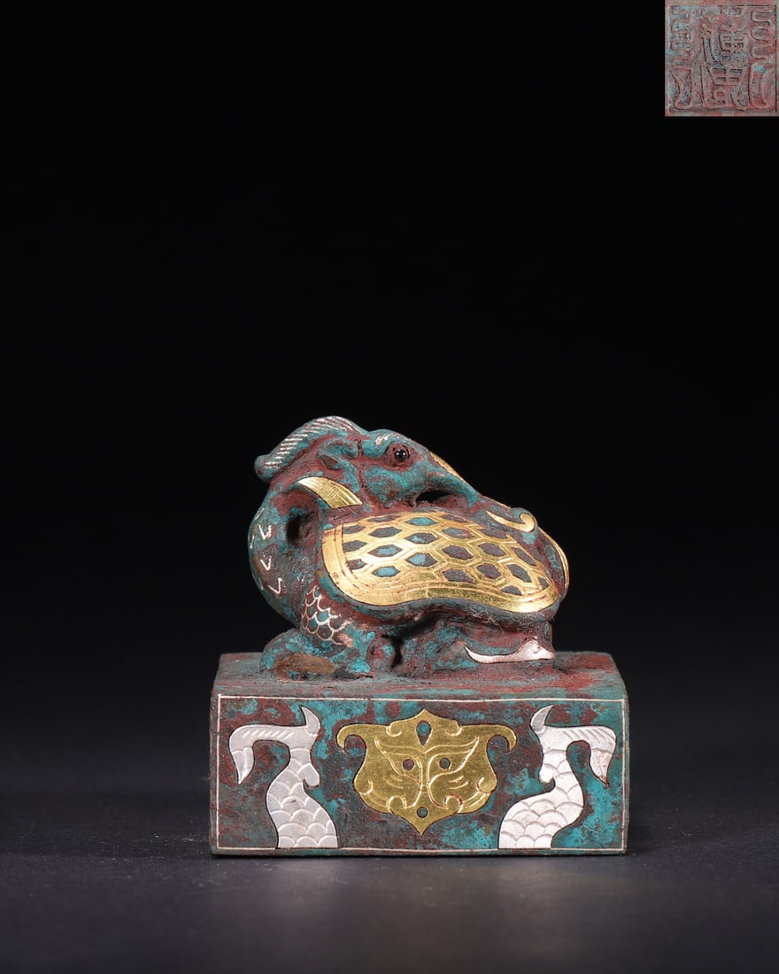 Han Dynasty, Gold and Silver Inlaid Bronze Seal with Xuanwu Knob: A Han Dynasty bronze seal with a gold and silver inlaid Xuanwu knob. Features a square base, intricate inlaid patterns, and seal script characters on the face. Fine craftsmanship, natural patina, and 