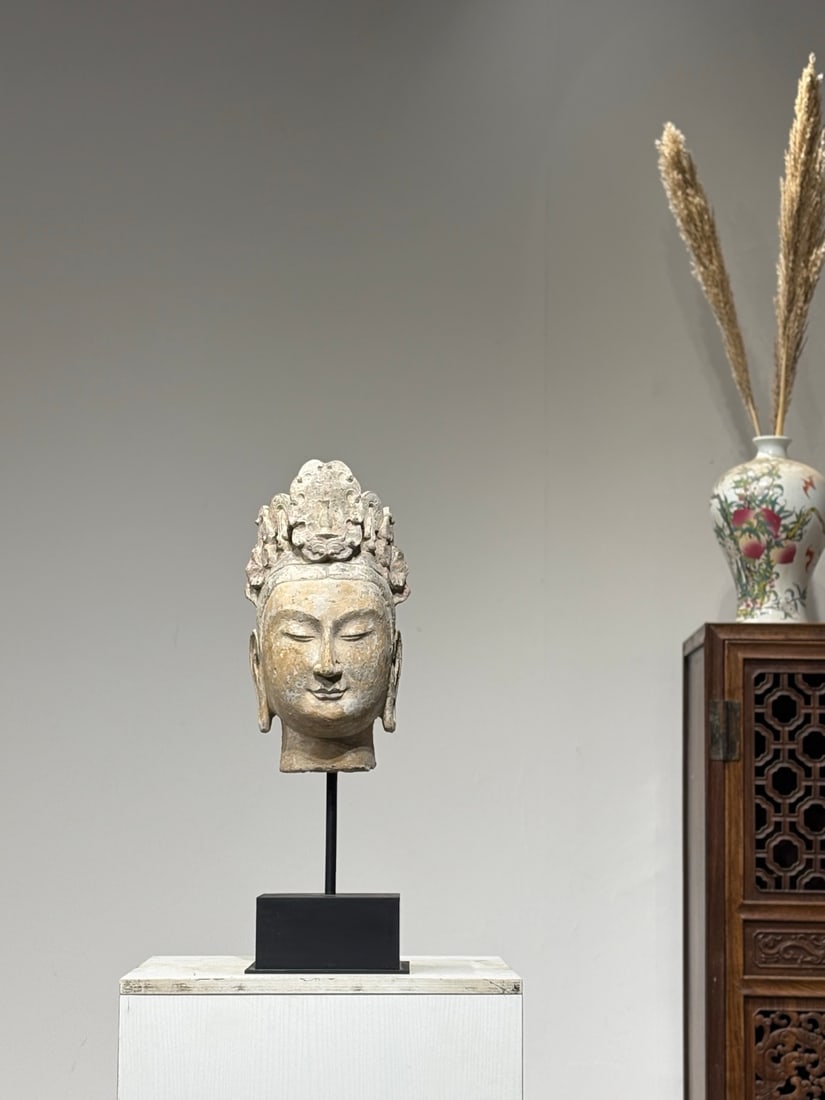 Song Dynasty, Stone Carved Guanyin Head: A sandstone Guanyin head carved in Song Dynasty. Ornate high-relief crown with vase and floral patterns, gentle serene facial features. Faded original red and white mineral pigments with natural weath