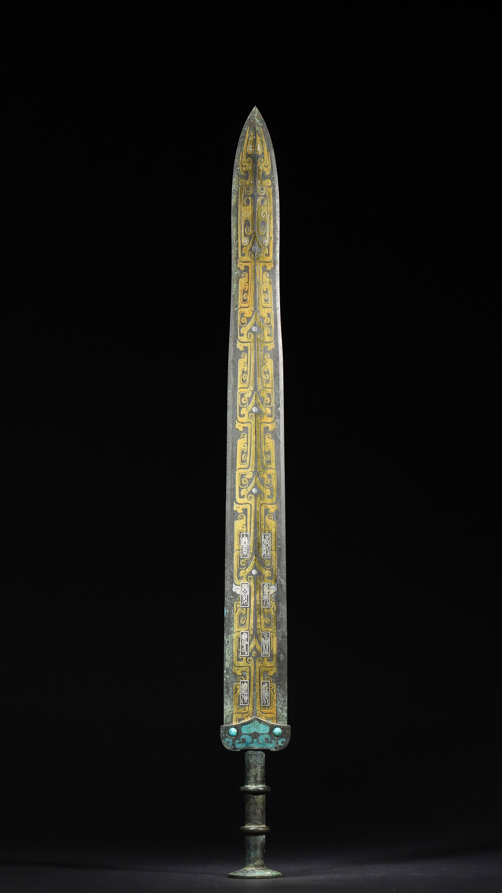 Warring States Period, Gold and Turquoise Inlaid Bronze Sword with Coiled Chi-Dragon Motifs: A fine Warring States bronze sword, featuring gold-inlaid coiled chi-dragon patterns, turquoise inlays, and bird-worm script inscriptions. It reflects the ritual system and craftsmanship of the period