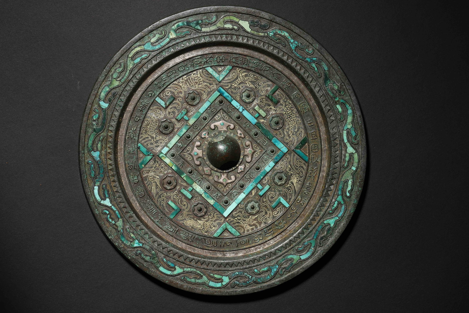 Han Dynasty Turquoise-Inlaid Bronze Game-Pattern Mirror: Mirror Back with "Bo-Ju" (Game Board) Pattern, Inlaid with Turquoise & Gilt, Surrounded by Inscriptions. A High-Rank Aristocratic Vessel of the Han Dynasty. Bo-Ju Mirrors Are Iconic of Han Mirrors. Wi