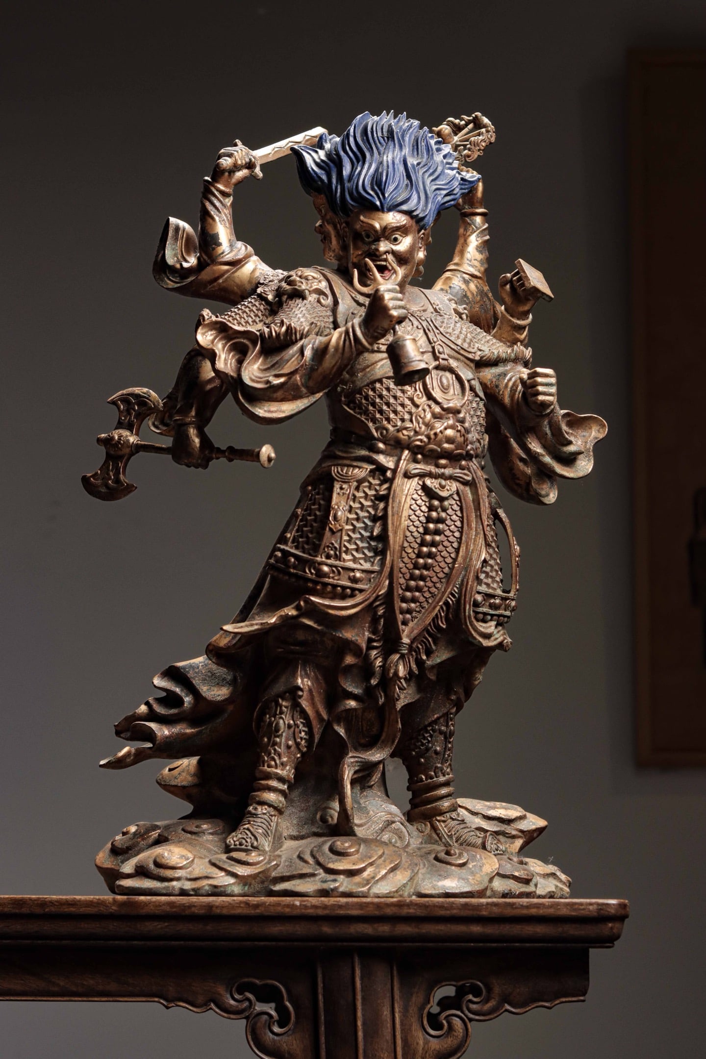 Qing Dynasty, Taoist Statue of Marshal Tianpeng: Gilt Bronze Taoist Statue of Marshal Tianpeng. This three-headed and six-armed figure has wide glaring eyes and an open mouth revealing teeth, with wrathful hair shaped like blue flames. Its six arms 