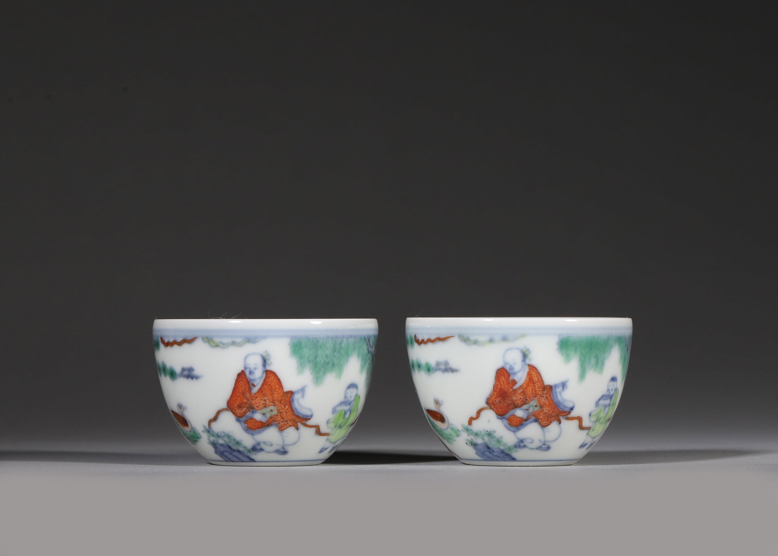 Ming Dynasty, Chenghua Period, Pair of Doucai Cups with Wang Xizhi Appreciating Geese: A pair of fine doucai porcelain cups of Chenghua reign, Ming Dynasty. Painted with the classic scene of Wang Xizhi watching geese, marked with six-character Chenghua script mark in square frame on bas