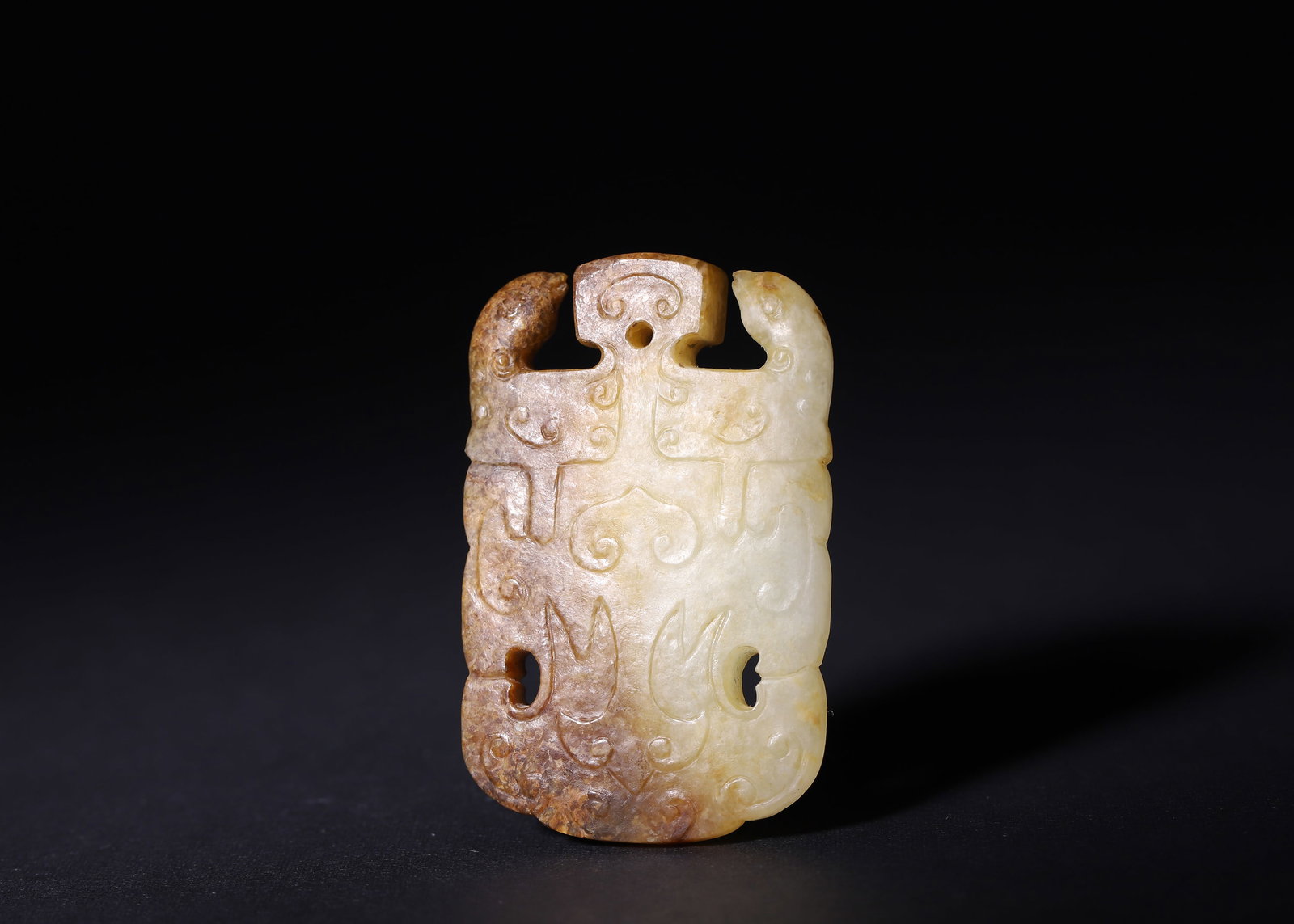 Warring States Period, White Hetian Jade Pendant with Twin Chi Dragons: Flat trapezoidal pendant of white Hetian jade, central suspension hole at top. Both sides shallow relief carved with symmetrical twin chi dragons covered in classic Warring States spiral scrolls, pair