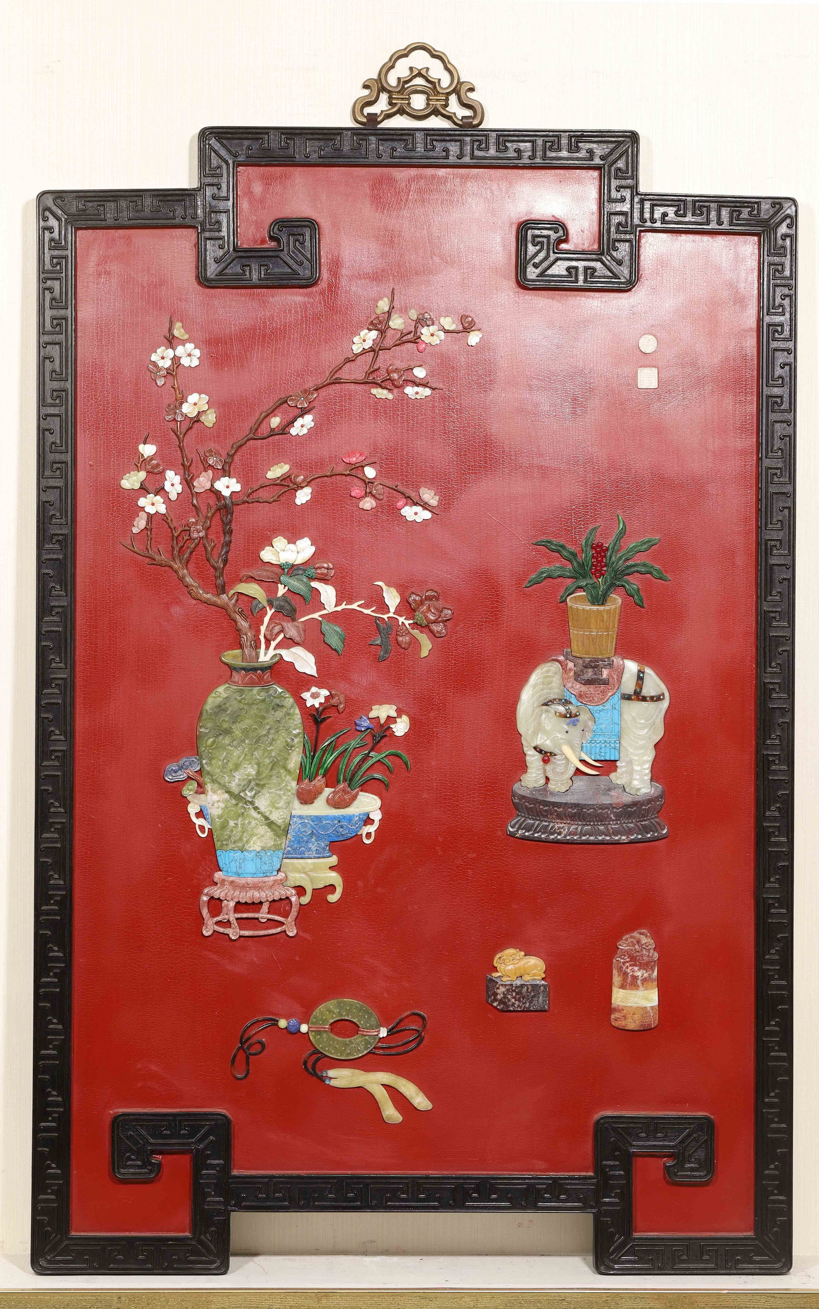 Red Lacquer Hanging Panel with Precious-Inlaid Antiquities and Elephant, Qing Dynasty (1644-1912): Cracked red lacquer ground within carved zitan frame with gilt bronze hanger. Precious inlay features elephant, vases and scholar objects, bears Qianlong mark, imperial-style wall ornament. Dimensions