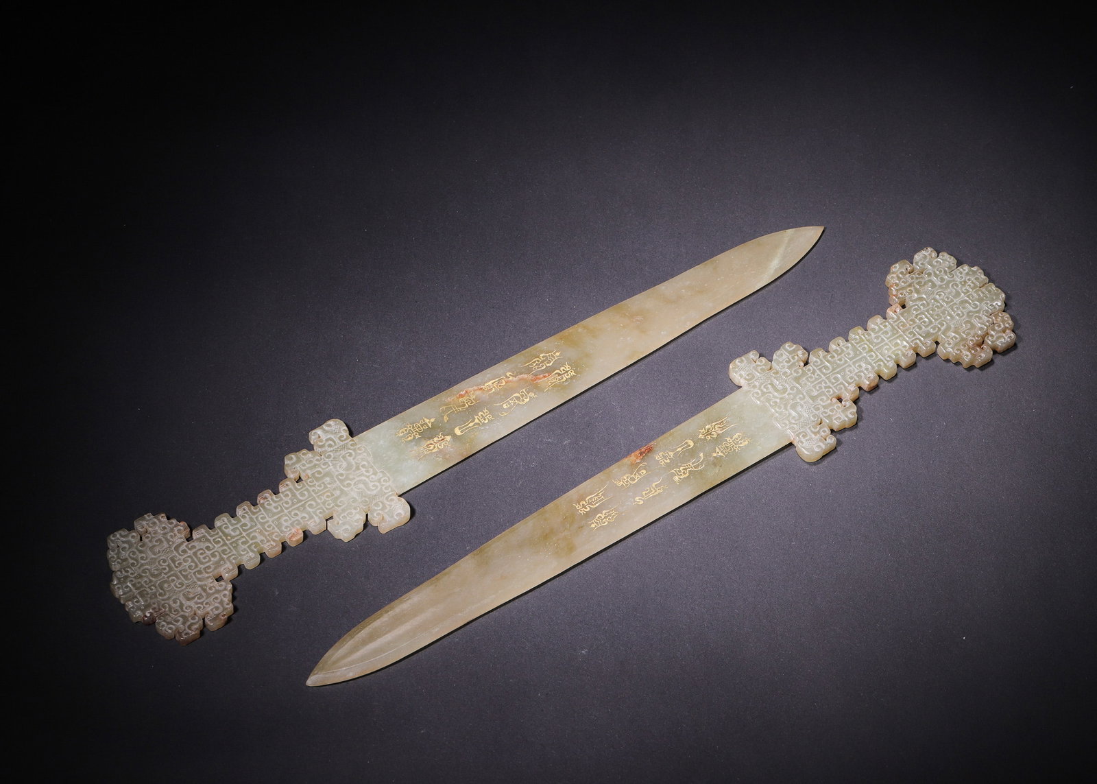 Han Dynasty, Pale Green Hetian Jade Ornaments with Openwork Hui Serpent Pattern, Pair: This matched pair of Table Piece is carved from single blocks of Hetian pale green jade, with smooth, fine texture and natural yellow-brown aged patina penetrating the stone. Each blade tapers to a sh
