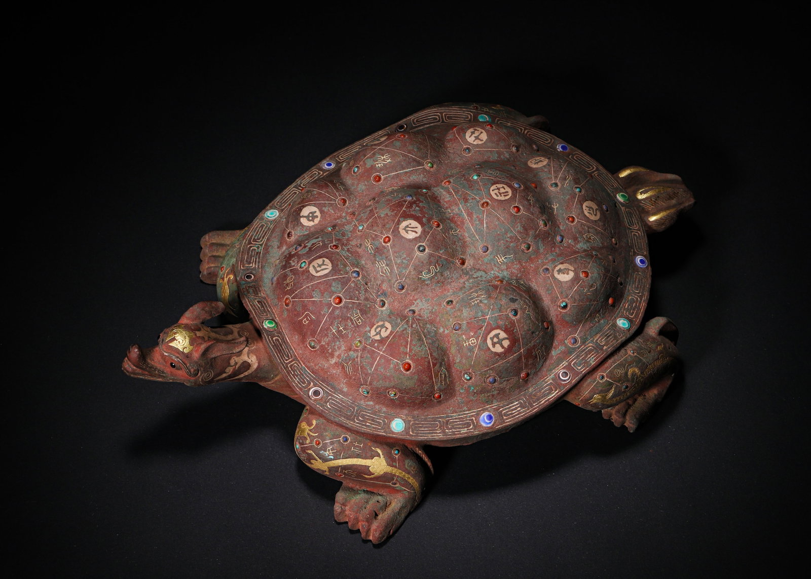 Han Dynasty, Gold, Silver, and Gemstone Inlaid Bronze Spirit Tortoise with Astronomical Motifs: Cast bronze spirit tortoise with articulated head bearing silver-inlaid inscription on the neck. The carapace is decorated with gold and silver inlaid stellar map interspersed with polychrome gemstone
