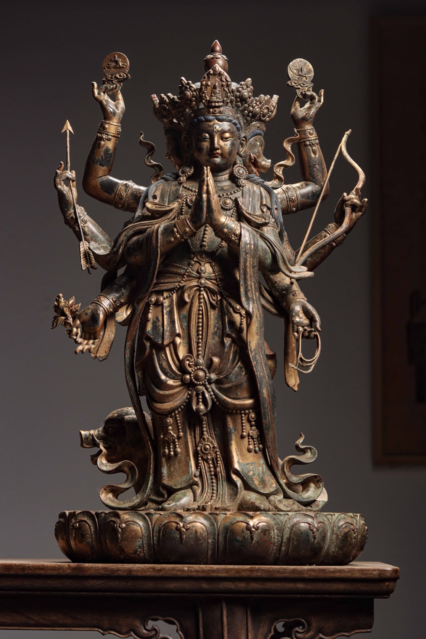 Qing Dynasty, Tibetan Statue of Marici (Goddess of Light): Gilt Bronze Tibetan Statue of Marici (Goddess of Light). The three-headed and eight-armed deity has a soft rounded face with eyes half-closed and gazing downward. It wears an ornate crown and tall coi