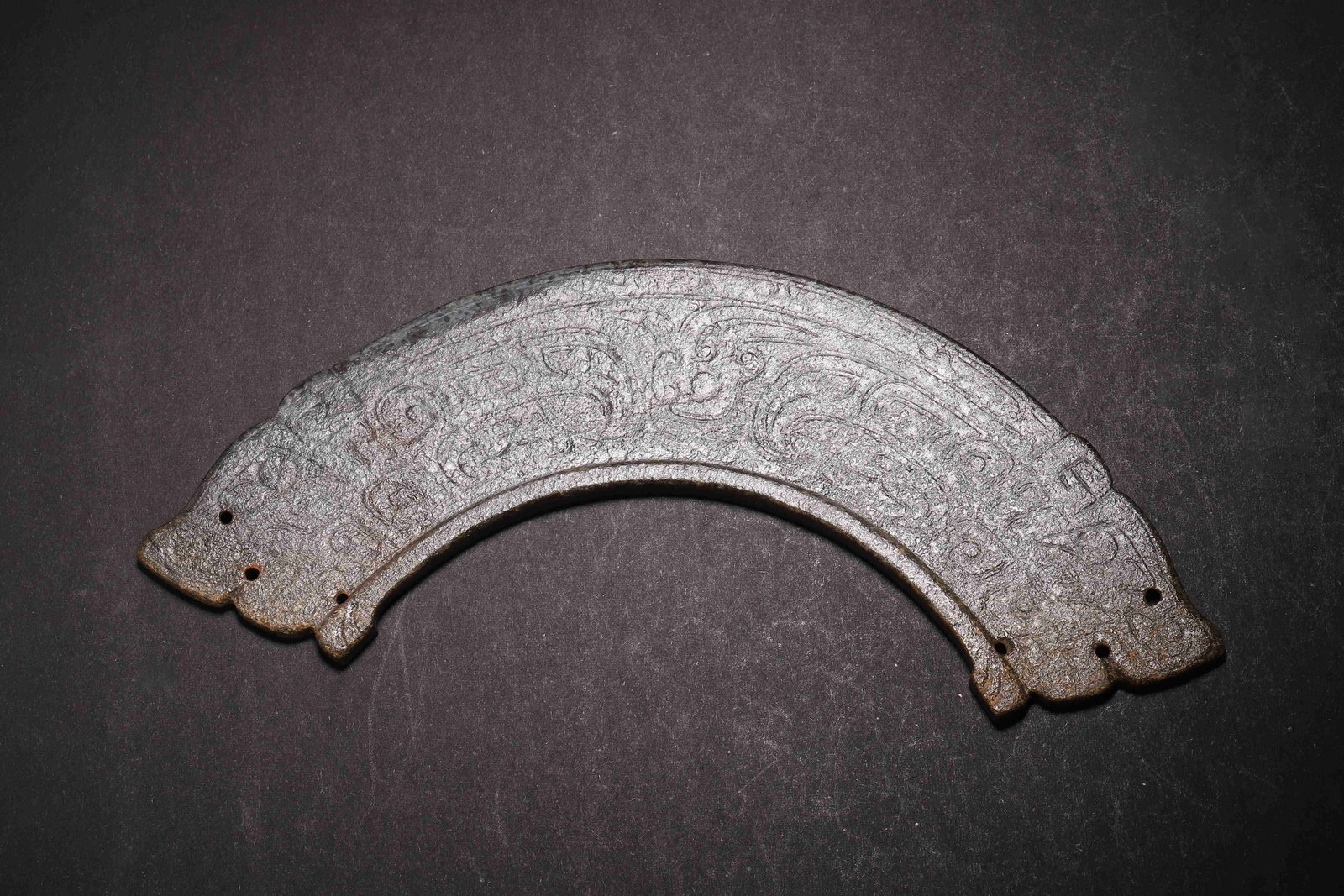 Phoenix-Pattern Jade Huang, Western Zhou Dynasty (1046-771 BC): Heavily patinated dark brown jade huang. Animal-head terminals,body incised with phoenix motifs. Perforated at ends for assembling into pendant sets. Dimensions: Length: 18cm (7.09in), Width: 7cm (2.7