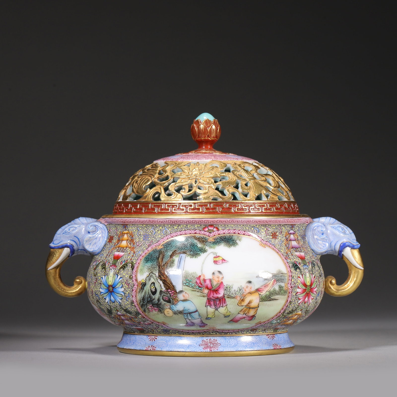 Qing Dynasty, Qianlong Period, Famille Rose Incense Burner with Elephant Handles: Qianlong marked incense burner with gilt elephant-shaped handles. Fully decorated famille rose scrolling flowers and eight treasures on grained ground, four panels depicting children playing in garden
