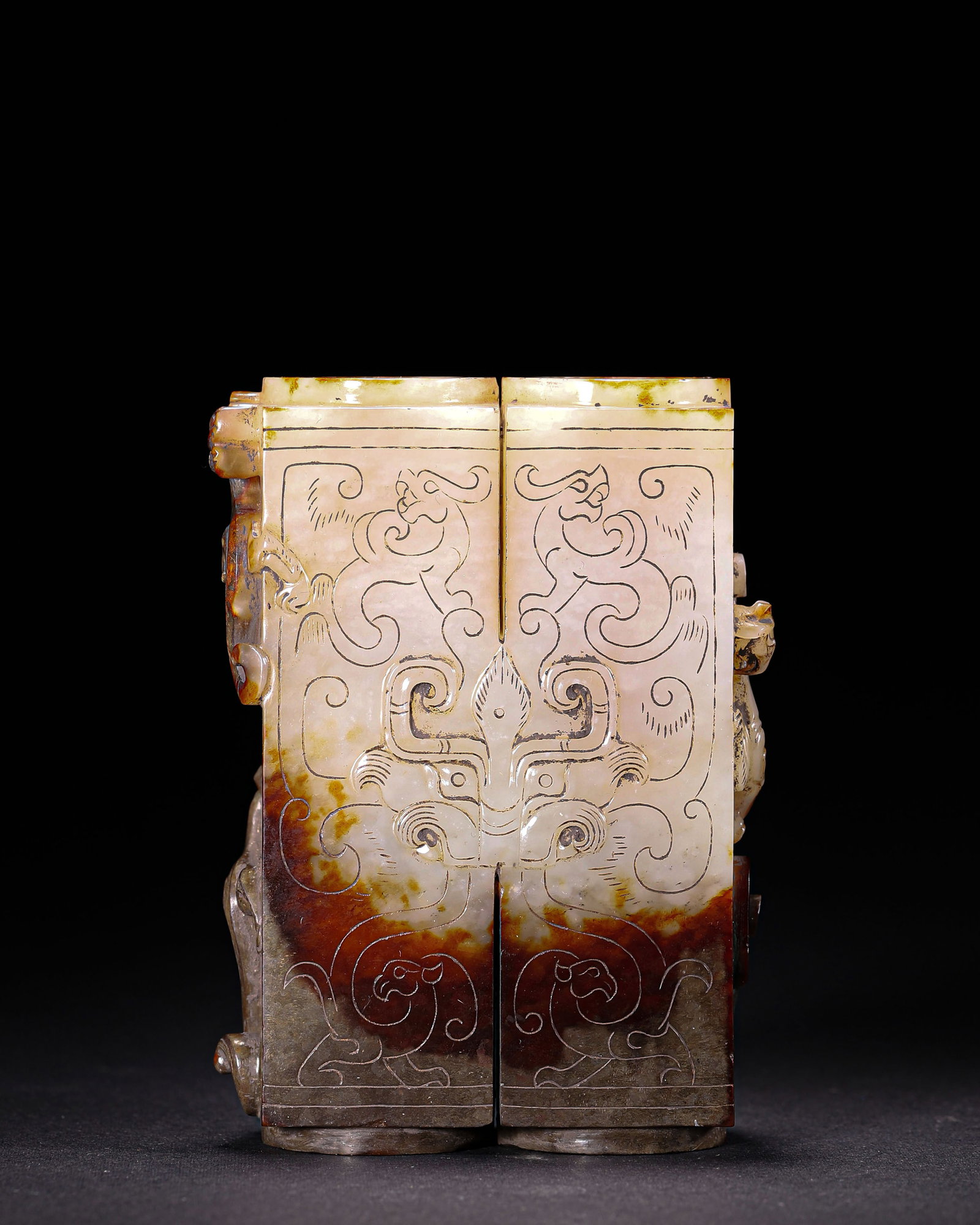 Han Dynasty, Hetian Jade Twin-Component Pendant with Relief Chilong Motifs: A combined twin part Hetian jade pendant with reddish brown natural patina. Decorated with incised and high relief taotie and chilong patterns, hollow through. Compact handheld size, forceful carving 