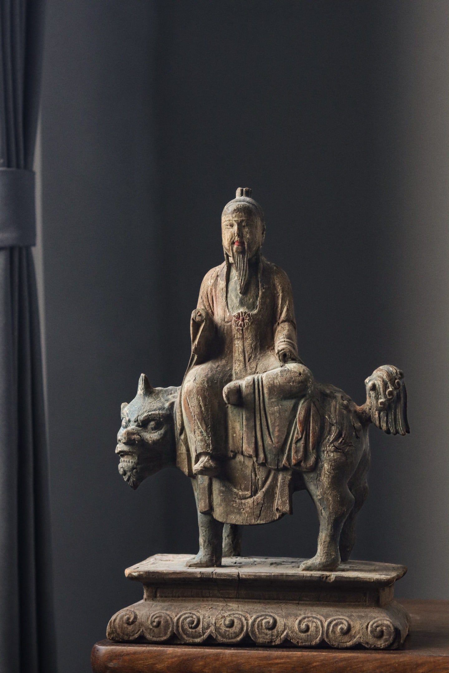 Ming Dynasty, Painted Wooden Statue of Taiyi Zhenren: A painted wooden statue of Taiyi Zhenren from the Ming Dynasty. The figure rides a mythical beast with flowing robes and a serene expression. Though the paint has faded, it retains its charm, embodyin