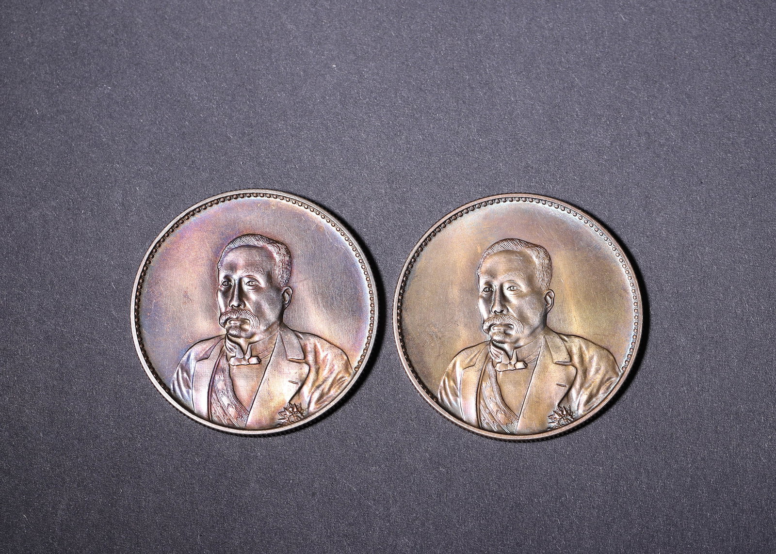 Republic of China (1912-1949 CE), Two Renshou Tongdeng Commemorative Silver Coins: Two commemorative silver coins with bust portrait on obverse. Reverse depicts pavilion scene and inscriptions. Natural colorful toning, fine relief and complete rims. Dimensions: Diameter: 3.9cm (1.54