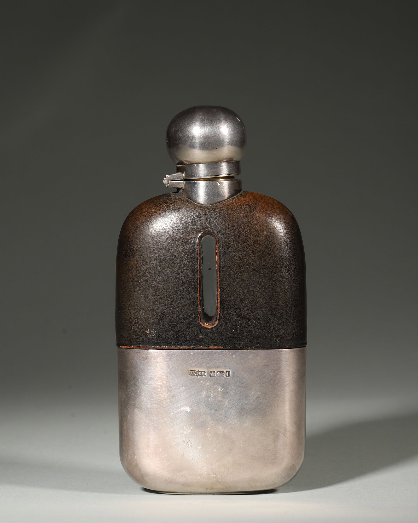 Edwardian Sterling Silver and Leather Hip Flask, James Dixon and Sons, Sheffield C.1910: A fine Edwardian sterling silver hip flask by James Dixon & Sons, Sheffield, c.1910s. Leather-clad with glass window, glass liner, fully hallmarked. Good condition with natural patina. Dimensions: Len