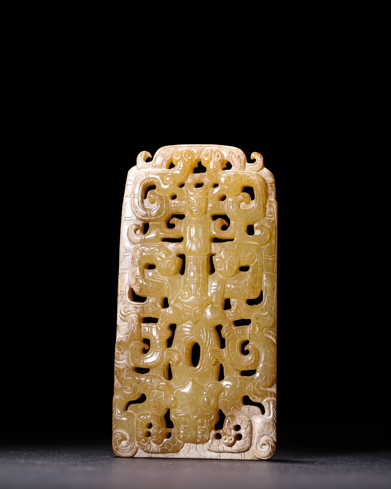 Han Dynasty, Hetian Jade Openwork Plaque with Deity and Dragon Motifs: Carved from Hetian jade in yellowish-brown tone with whitish suffusion on edges. Well-shaped openwork plaque featuring central deity surrounded by dragons, distinct layered carving and ancient patina,