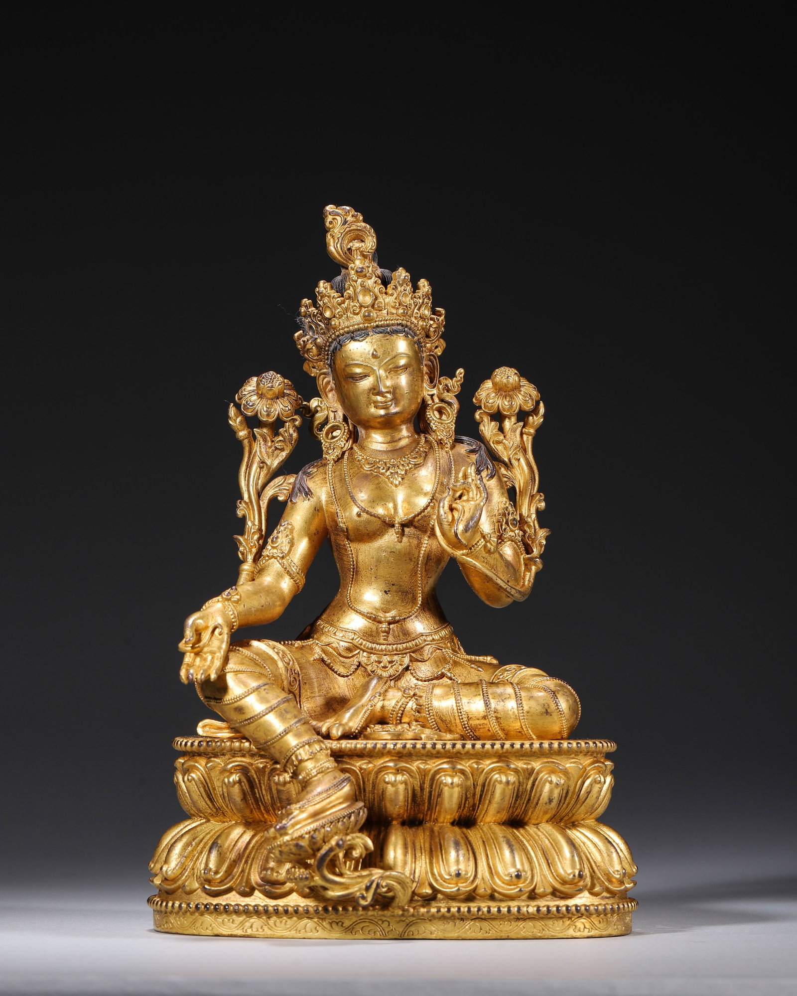 Qing Dynasty, Gilt Bronze Seated Statue of Green Tara: A fine gilt bronze Green Tara statue of Qing Dynasty for Tibetan worship. Thick intact gilding covers the whole body. The compassionate deity holds lotus blossoms and sits in relaxed pose on double lo
