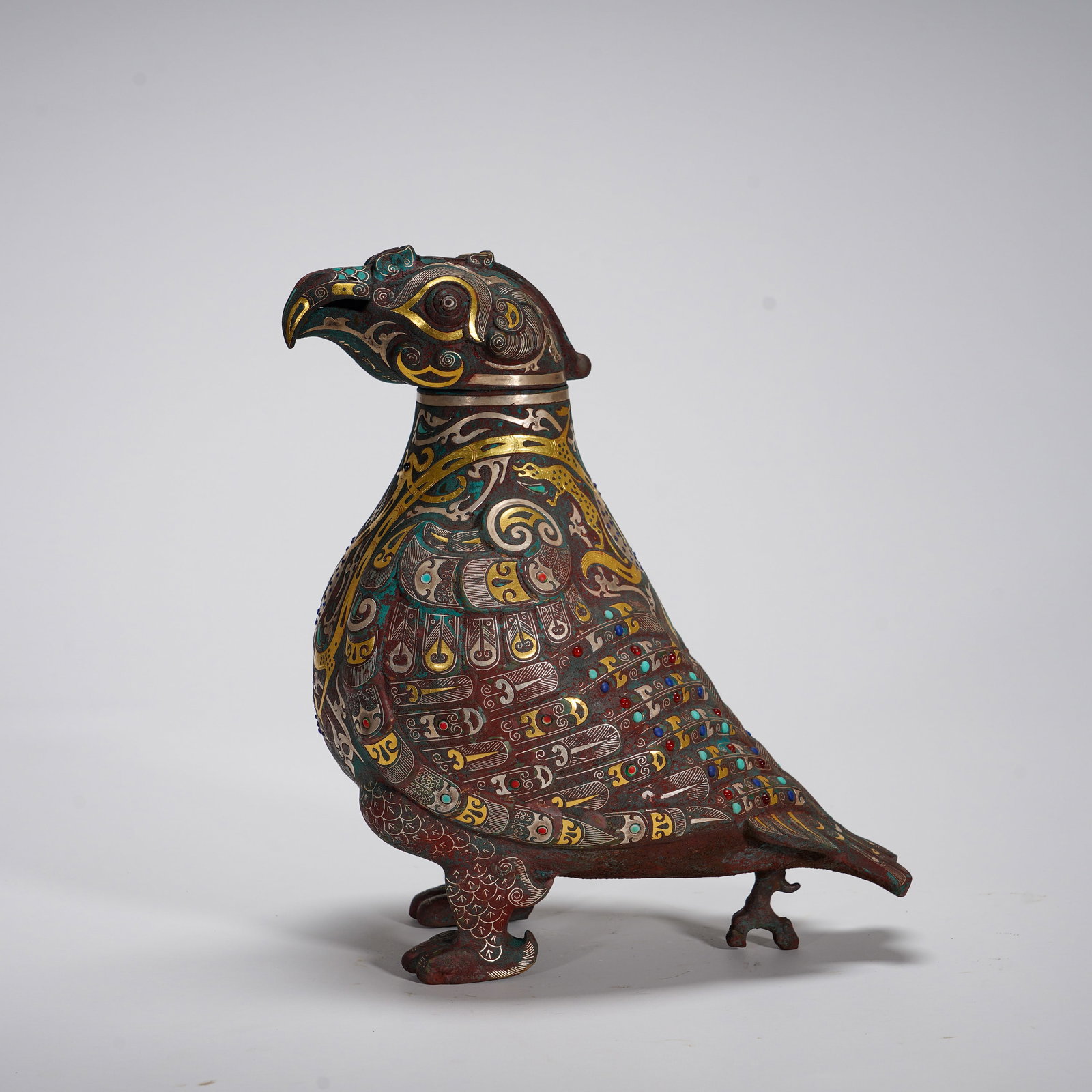 Inlaid Gold and Silver Multi-Treasure Bird-Shaped Vase: This bronze vessel is modeled after a sacred bird, with its head serving as the lid. The whole body adopts elaborate gold-and-silver inlay craft. Feather patterns are finely depicted across the body, 