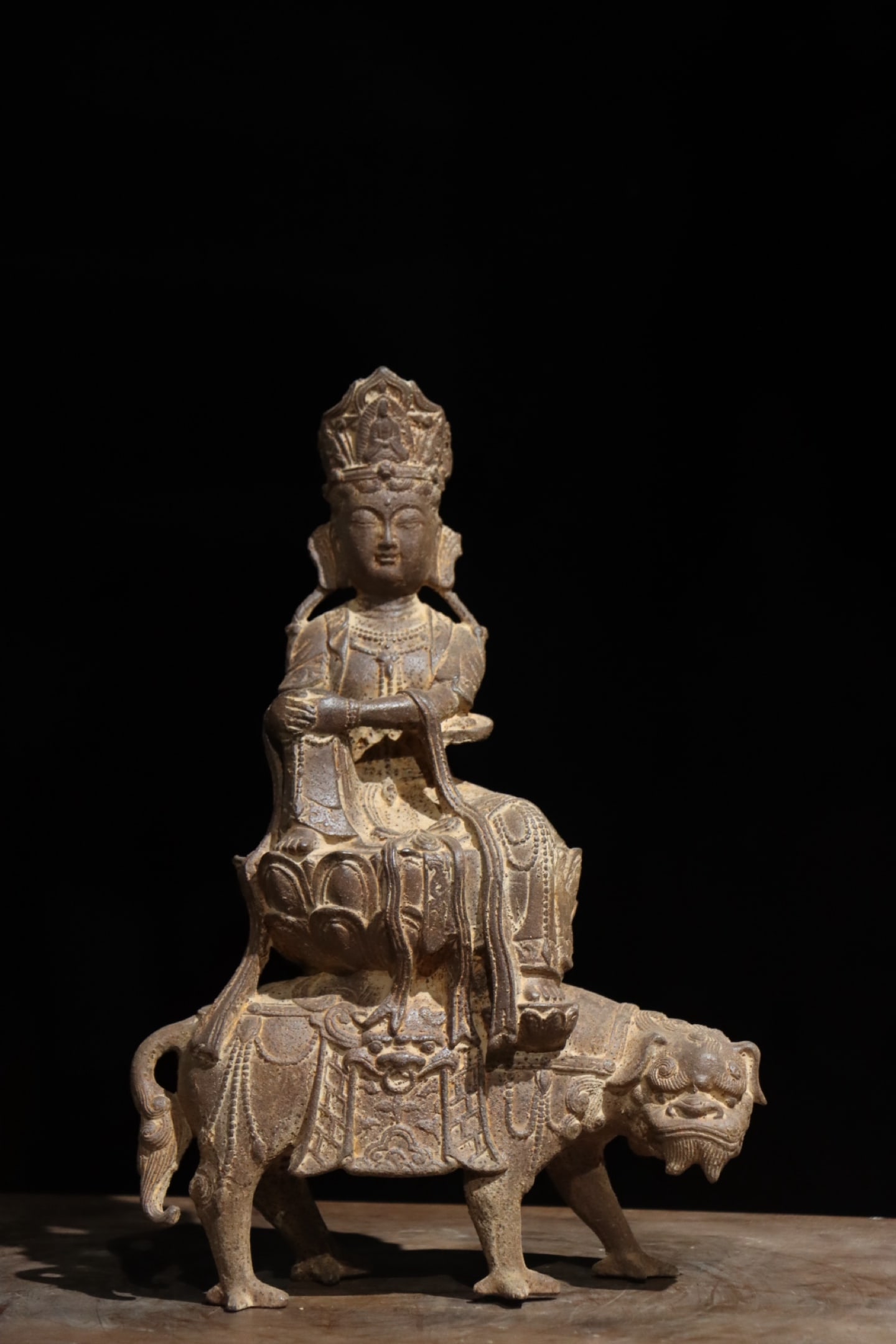 Ming Dynasty, Cast Iron Statue of Manjusri Bodhisattva Riding a Lion: Cast integrally from pig iron via mold casting; Manjushri sits atop lotus flower mounted on lion??s back, covered with aged natural rust, a devotional statue for folk shrine worship in Ming and Qing d