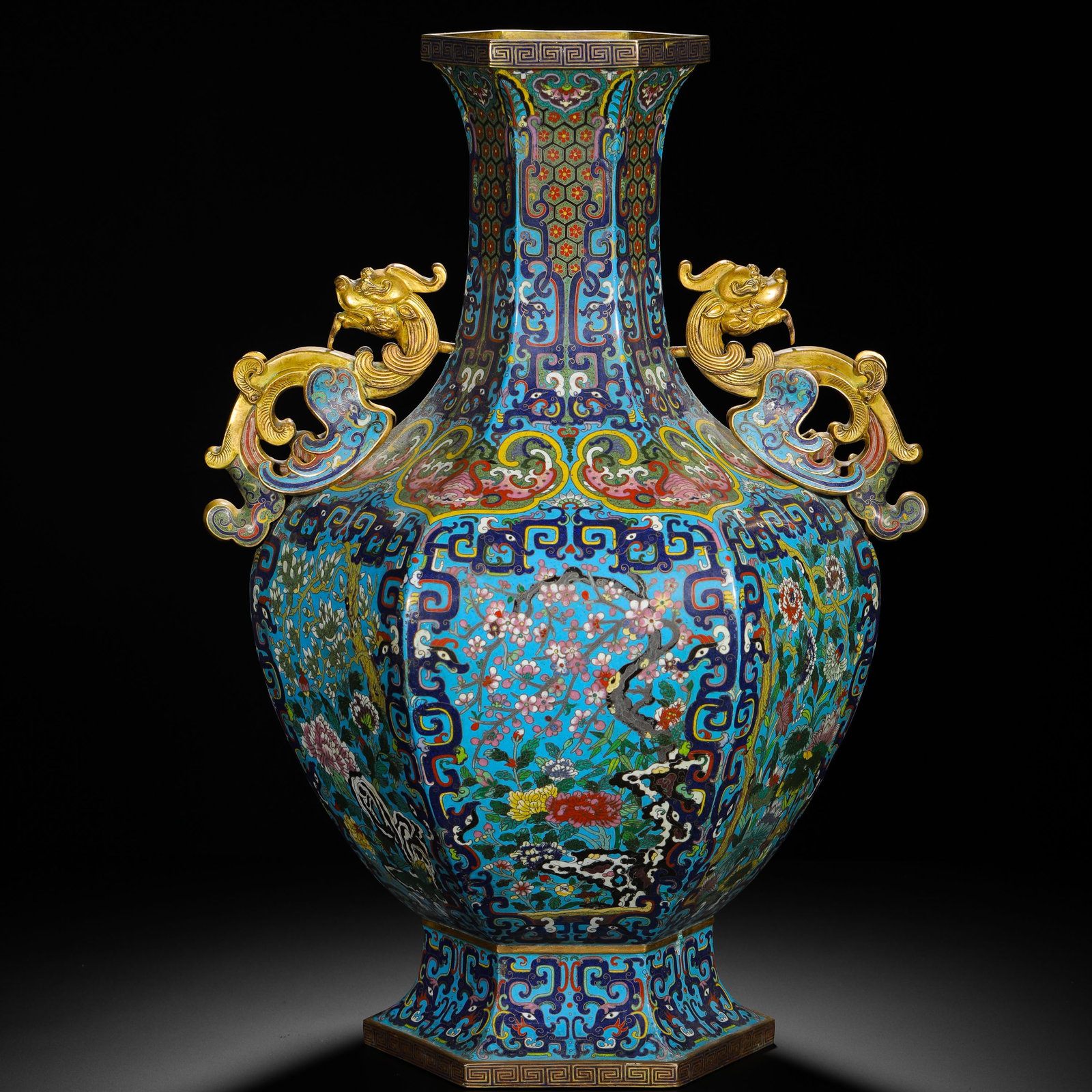 Qing Dynasty, Copper Body Cloisonne Enamel Flower-And-Bird Pattern Gilded Eared Hexagonal Vase: A Qing Dynasty palace-style cloisonne hexagonal vase, featuring fine craftsmanship and ornate decoration. The vase has a hexagonal body with traditional patterns such as meander and brocade designs on