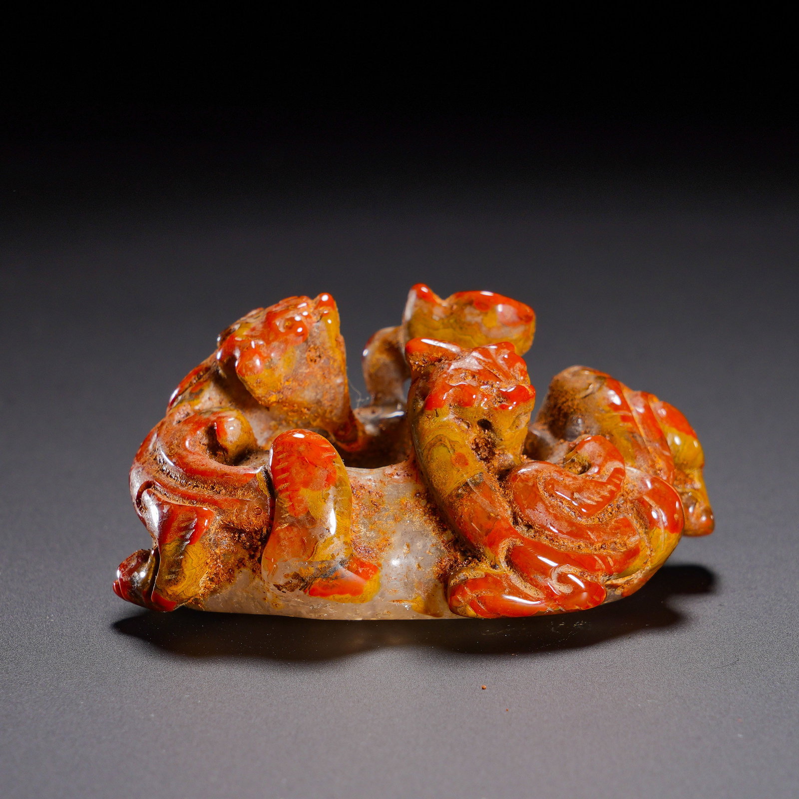 Han Dynasty, Red Agate High Relief Double Chi Dragon She Shape Pendant: Carved from Warring-States red agate, this she-shaped pendant presents gorgeous red-yellow hues, covered with ancient earth patina and heavy aged gloss. Following the classic form of Han-dynasty she-p