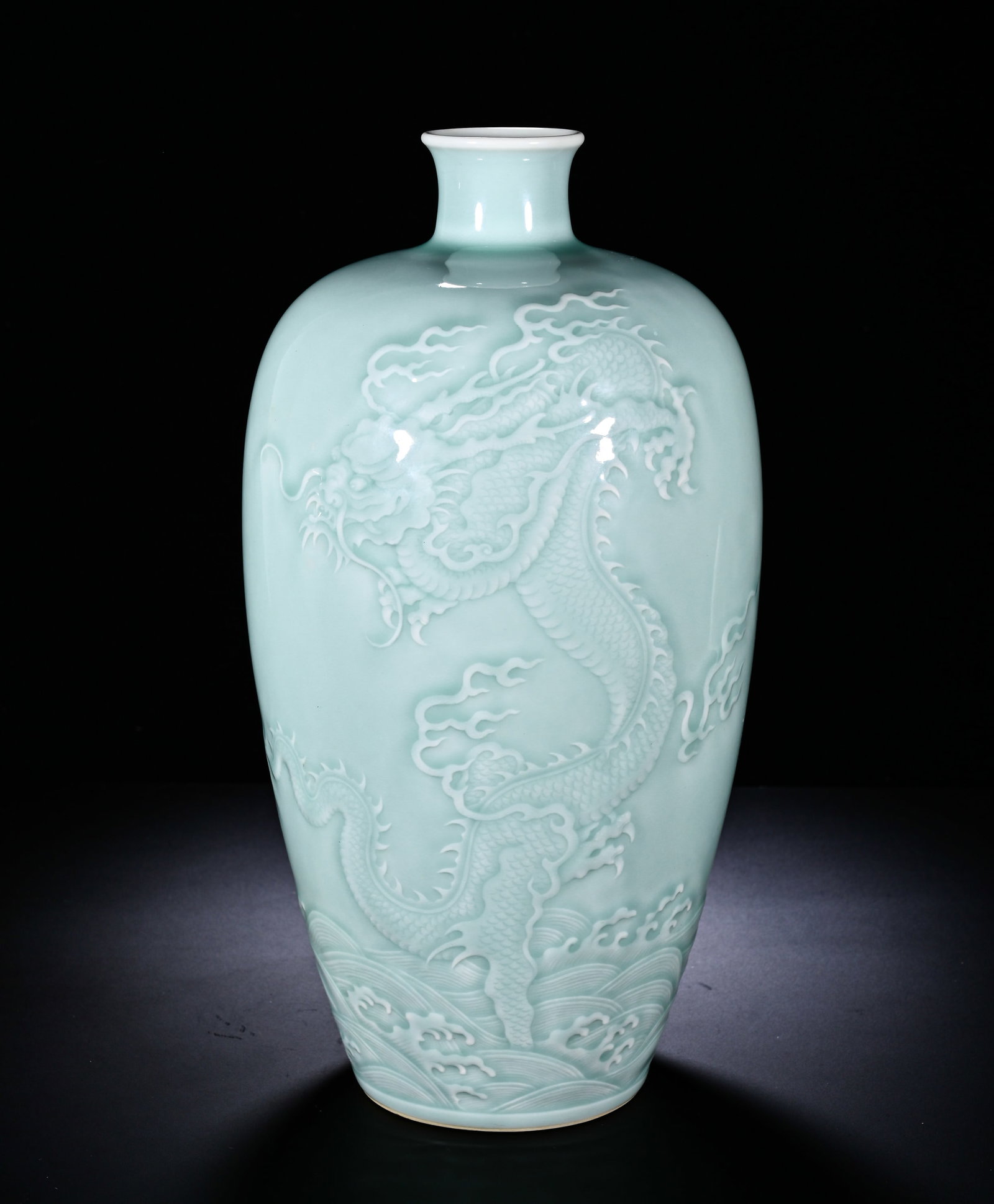 Qing Dynasty, Kangxi Powder Blue Glaze Embossed Sea Dragon Pattern Plum Vase: The classic prunus-form mei-ping vase has small mouth, short neck, full shoulder, elongated tapering body and ring foot. It is fully covered with soft even light-celadon glaze with smooth lustrous sur
